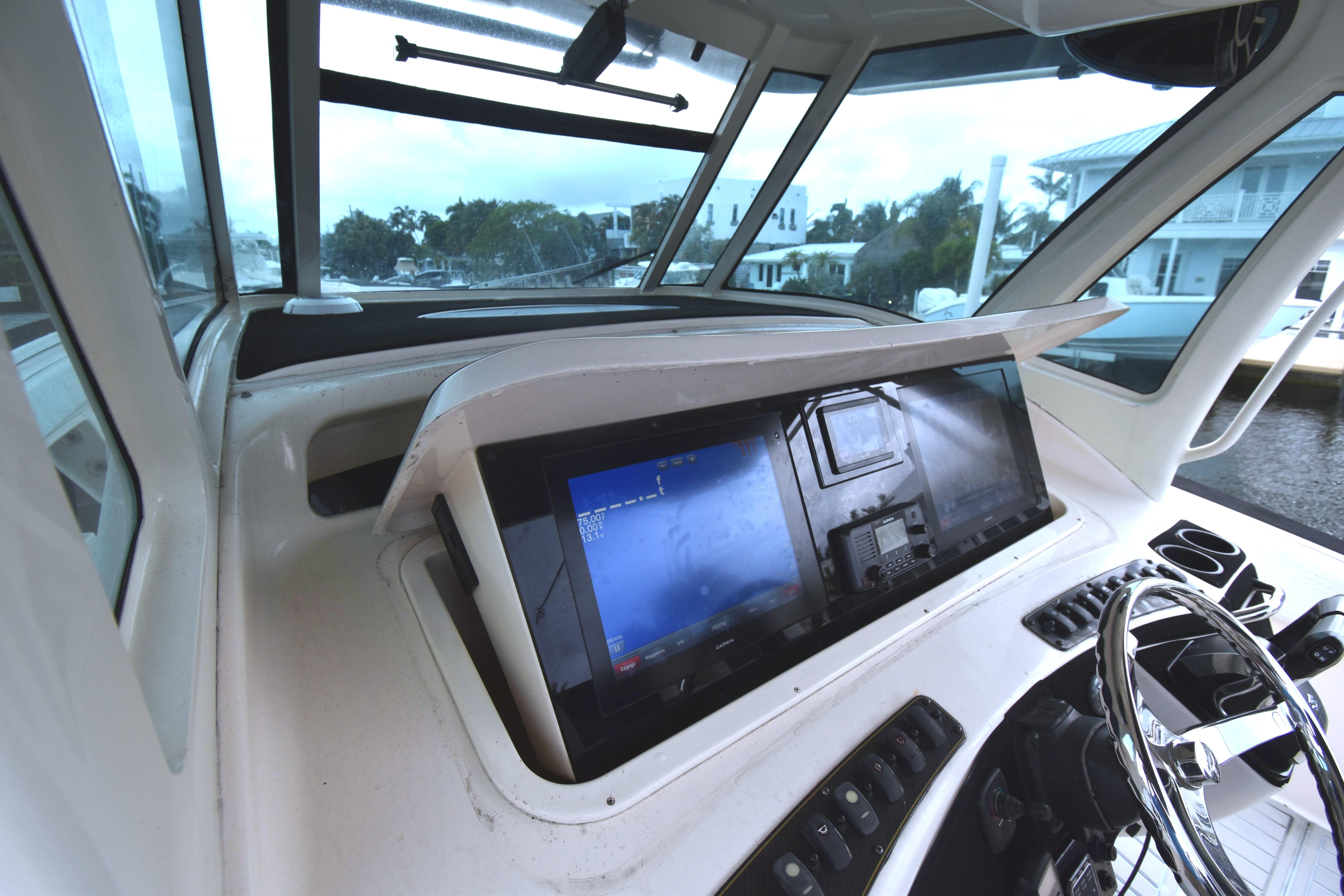 2010 Grady-White Canyon 366 helm with navigation screens and steering wheel.