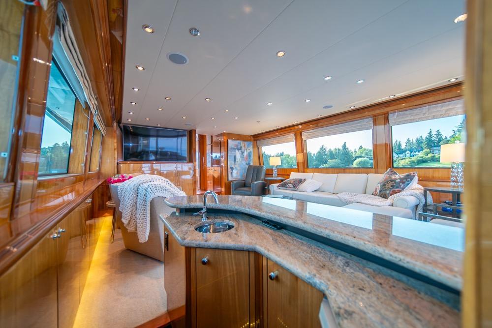 Luxurious interior of 2008 Hatteras 72 Motor Yacht with elegant wood finishes and spacious seating.