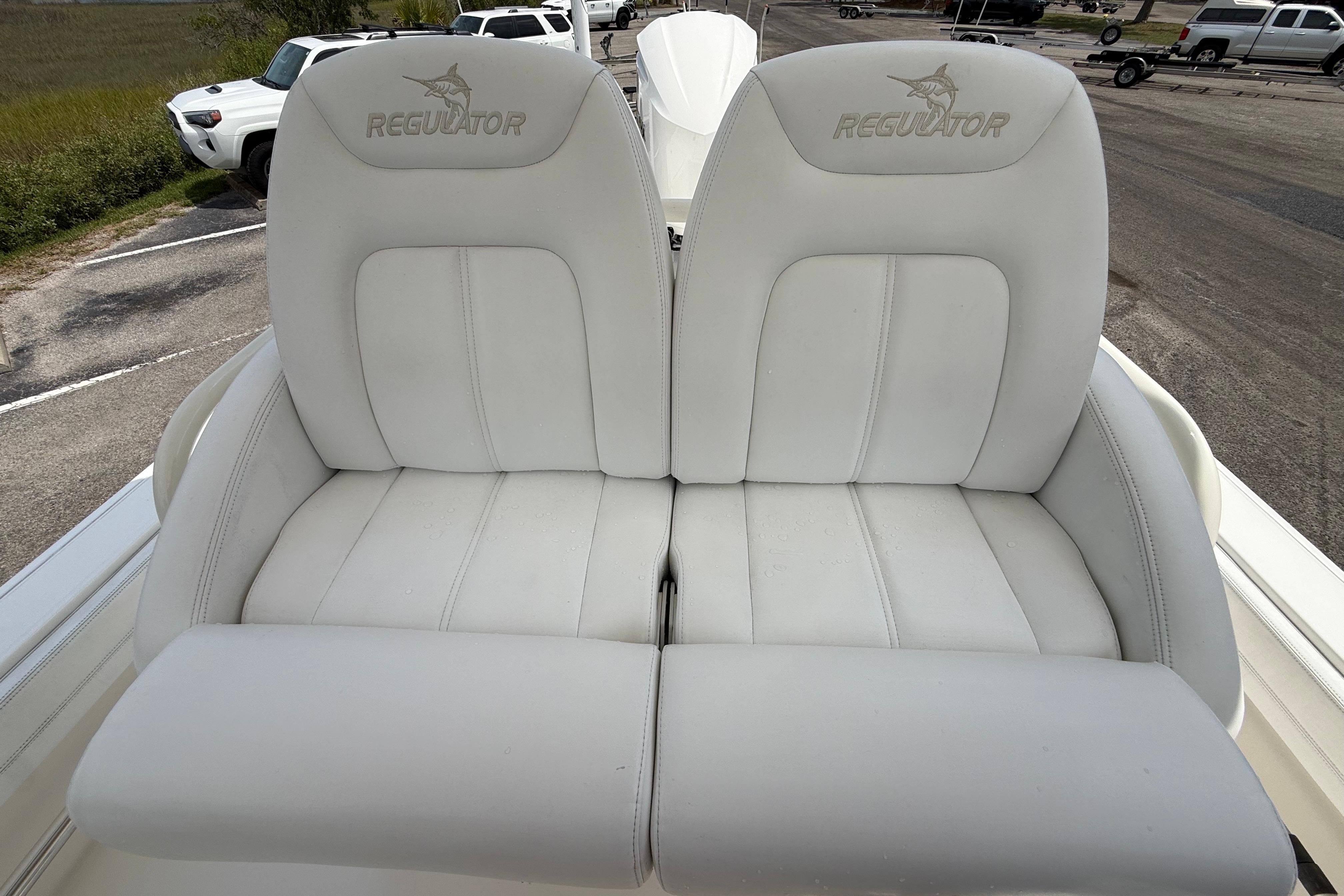 2019 Regulator 26XO boat seats with logo, parked in a lot.