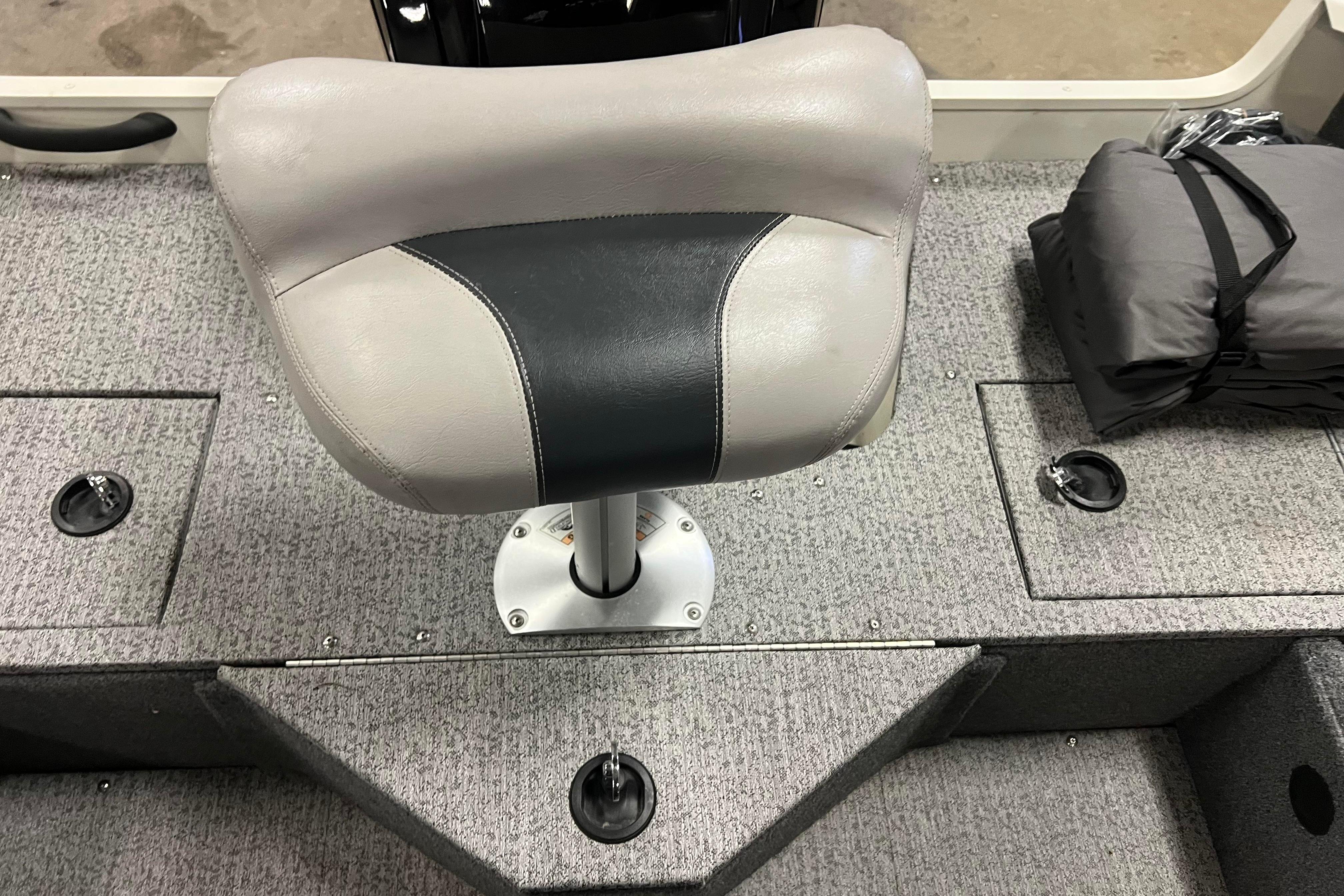 2022 Tracker Pro Guide V-16 WT boat seat on carpeted deck.