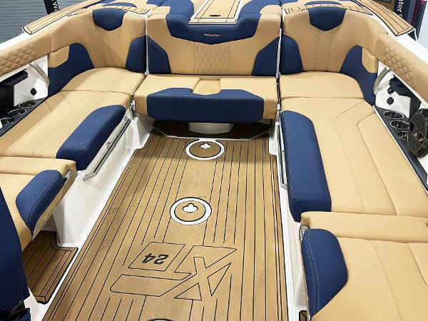 2022 MasterCraft NXT24 boat interior with tan and blue seating, teak-style flooring.