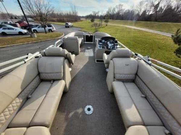 2023 Ranger Reata 243C pontoon boat with spacious seating and modern dashboard.