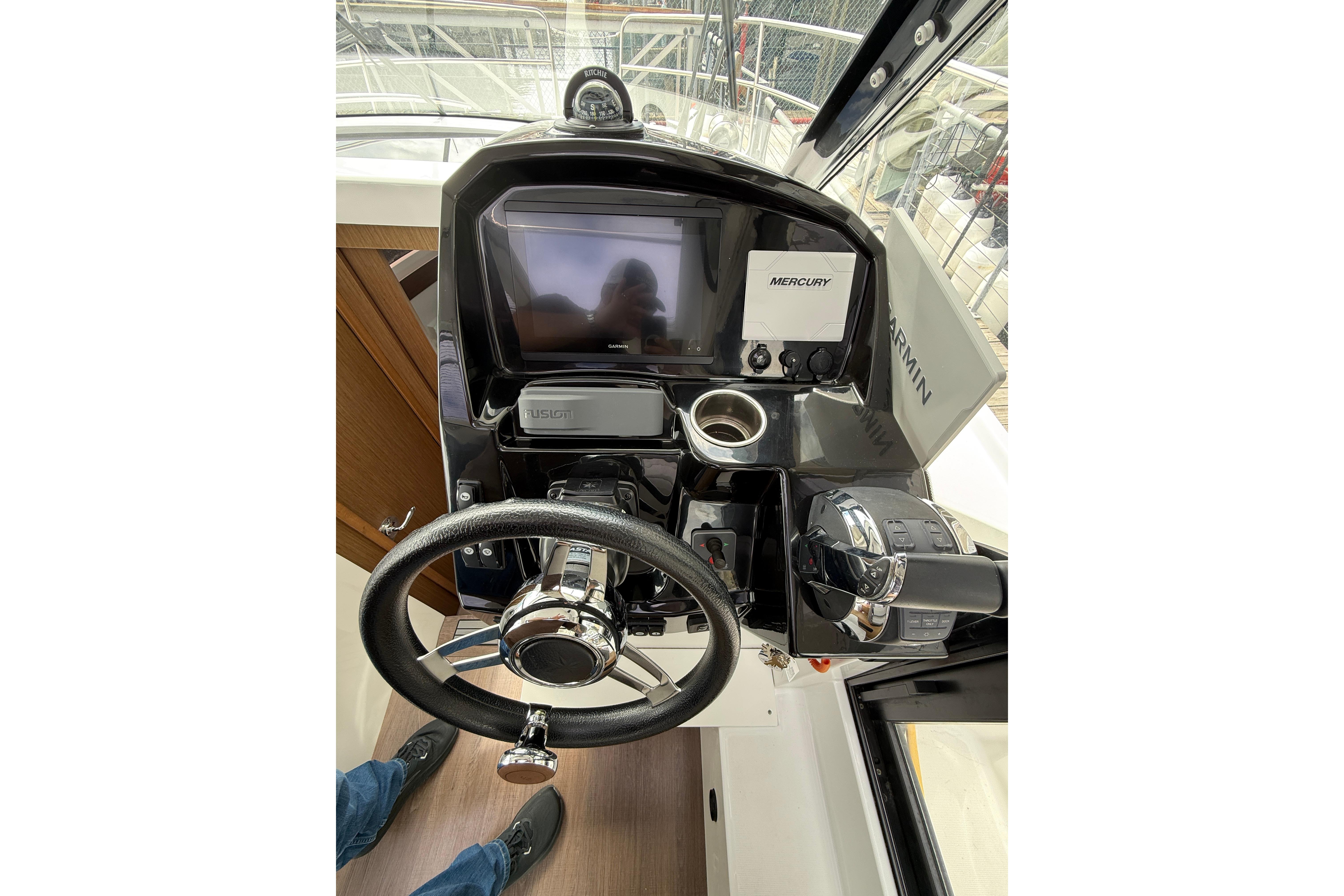 2020 Jeanneau NC 895 helm with steering wheel, Garmin display, and Mercury controls.