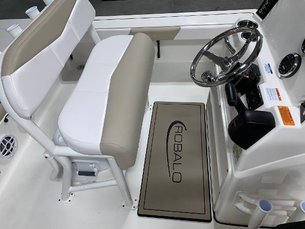 2026 Robalo 226 Cayman boat interior with steering wheel and seating area.