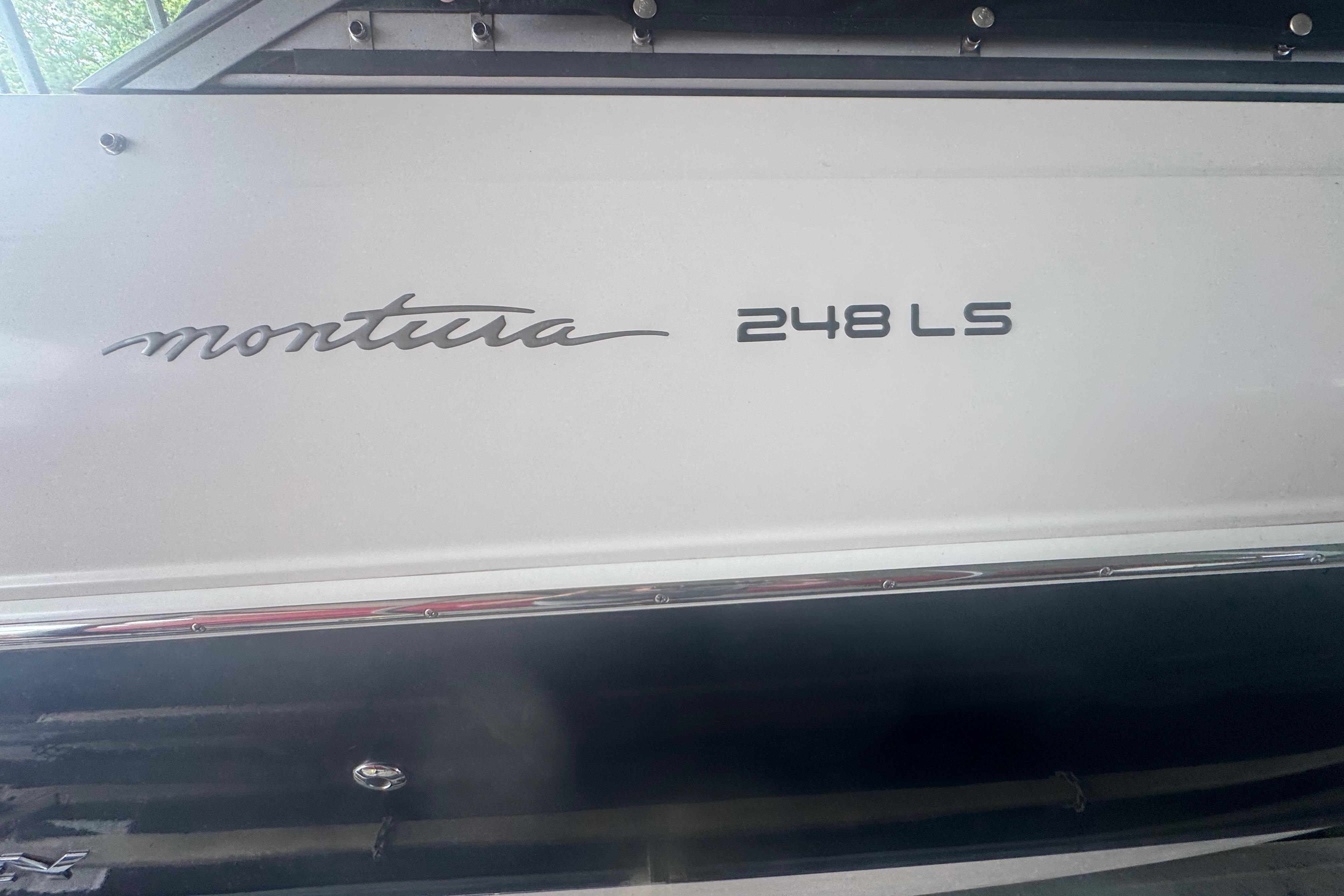 2005 Monterey 248LS Montura Bowrider boat side view with model name displayed.