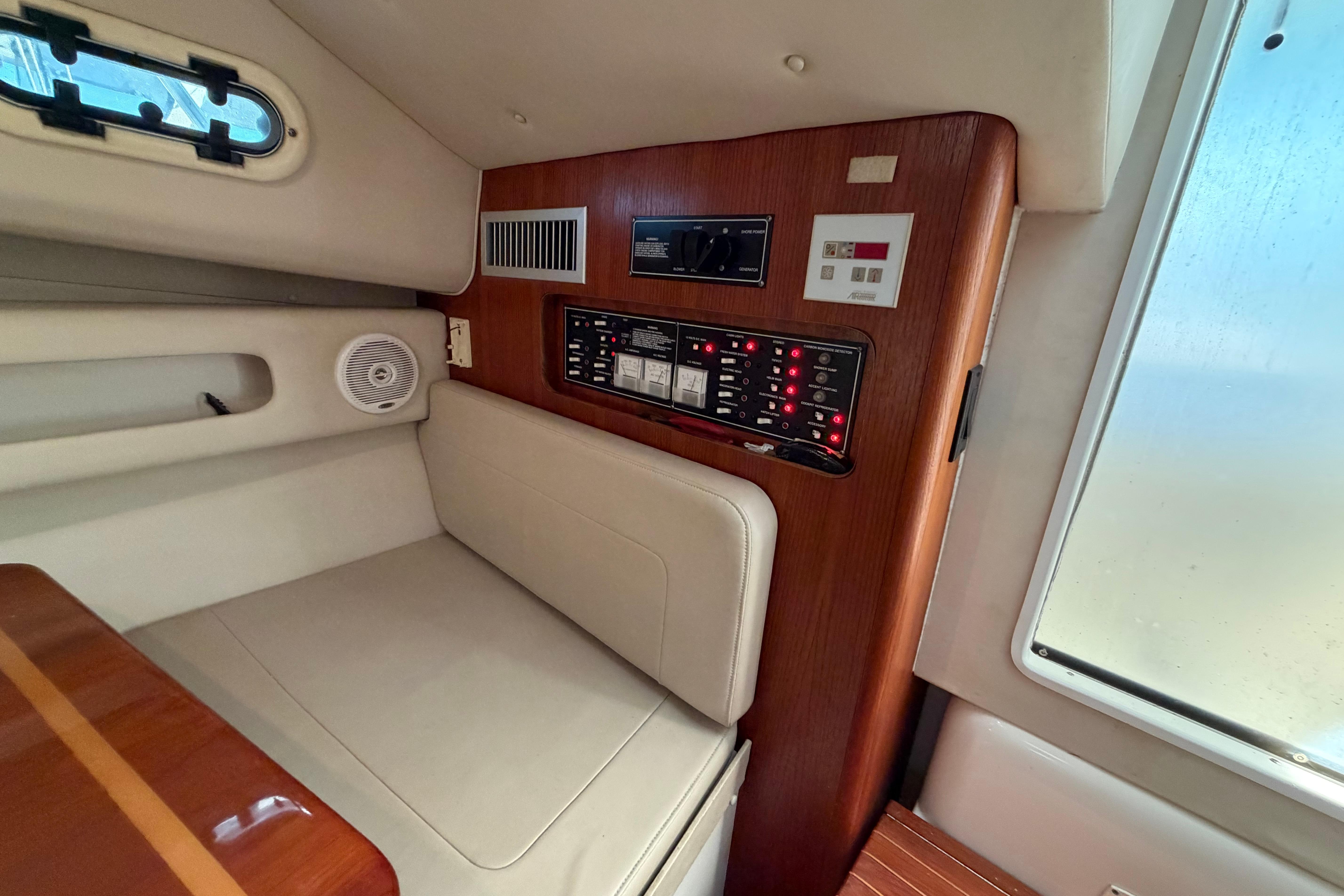 Interior of 2001 Pursuit 3000 Express boat with control panel and seating area.