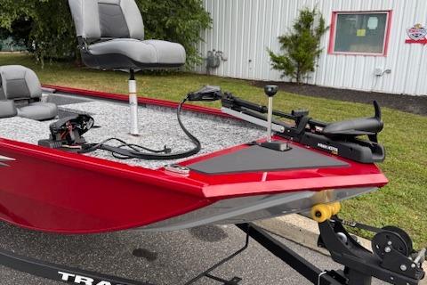 2026 Tracker Pro 170 boat with red exterior and modern seating, parked outdoors.