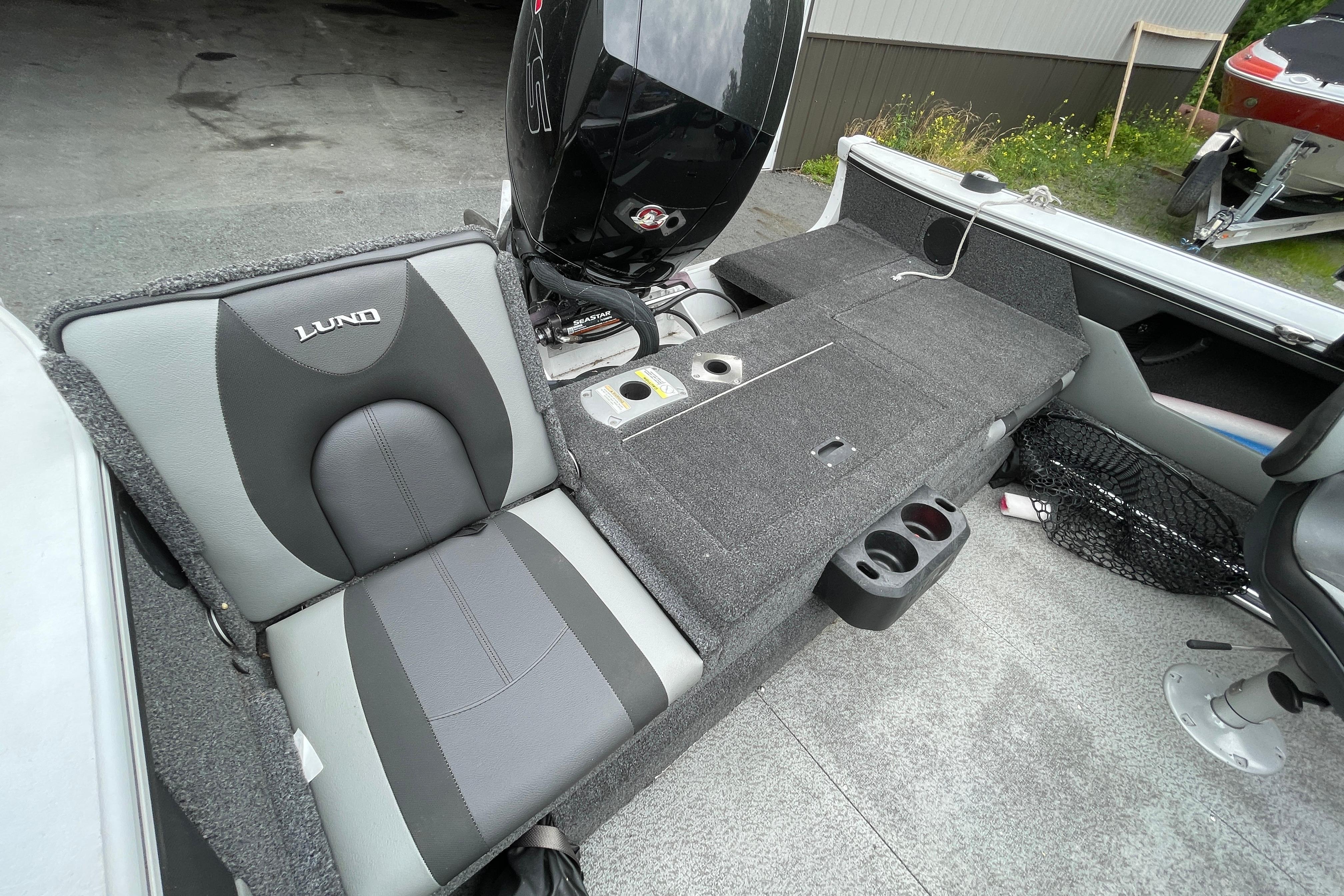 2022 Lund 1875 Crossover XS boat interior with seating, storage, and motor.