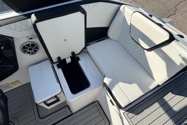2026 Yamaha Boats 222S interior with white seating and storage compartment.