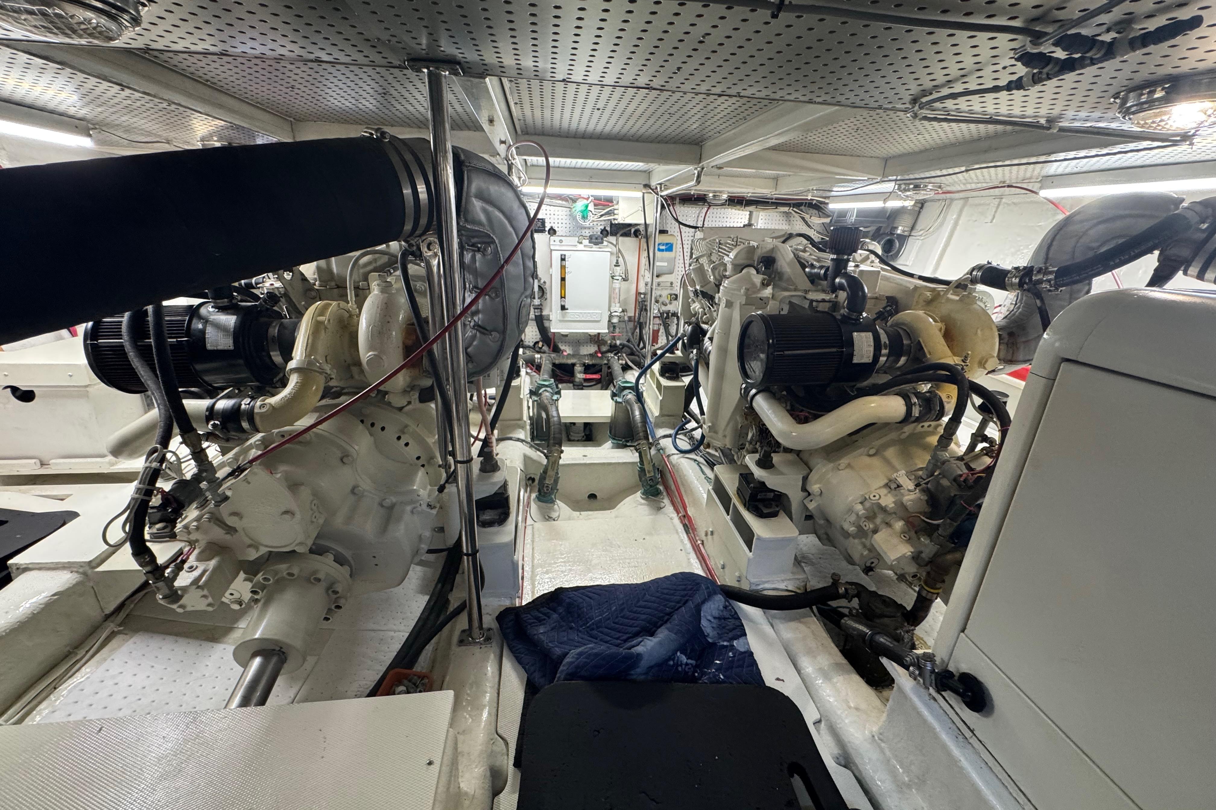 Engine room of a 2002 Hampton 550 yacht, showcasing dual engines and mechanical components.