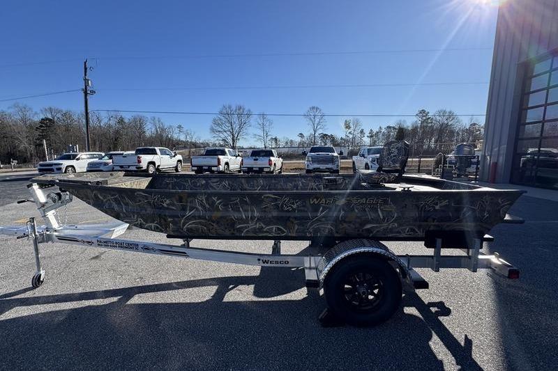2026 War Eagle 648LDV boat on trailer, parked outdoors under clear sky.
