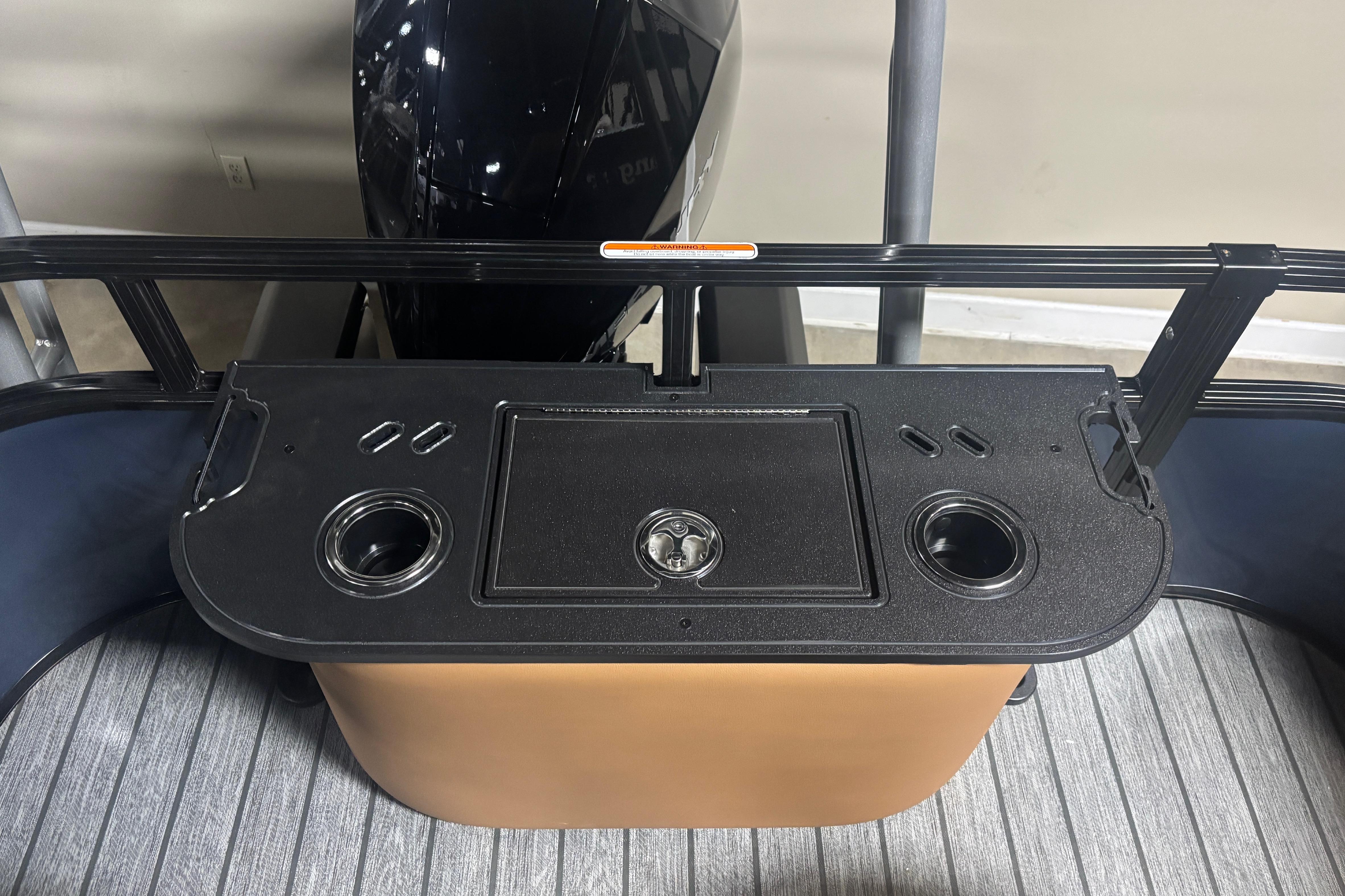 2026 Ranger 223F boat console with cup holders and storage compartment.