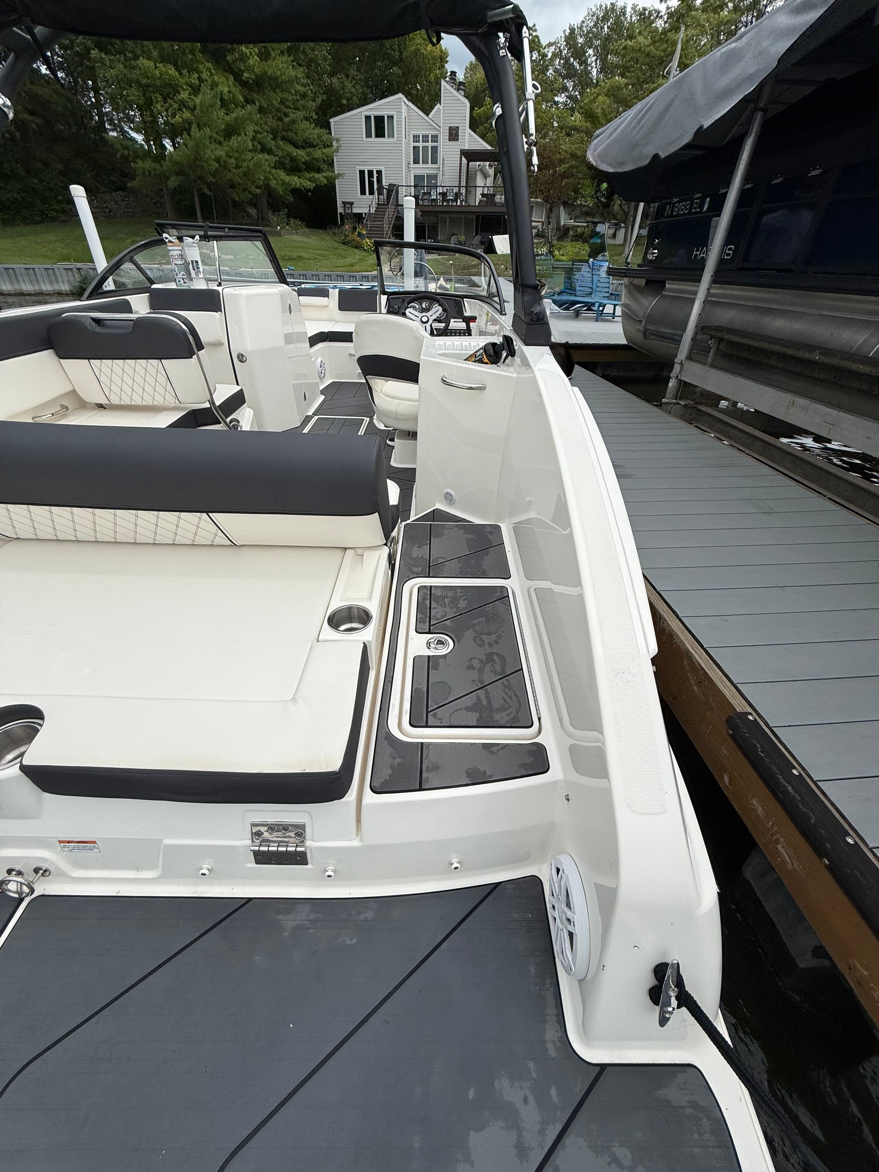2022 Bayliner DX 2250 boat interior with seating and docked at a marina.