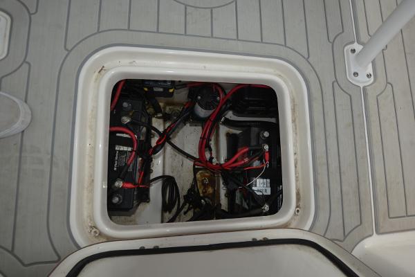 2021 Sea Pro 228 Bay boat battery compartment with wiring and connections.