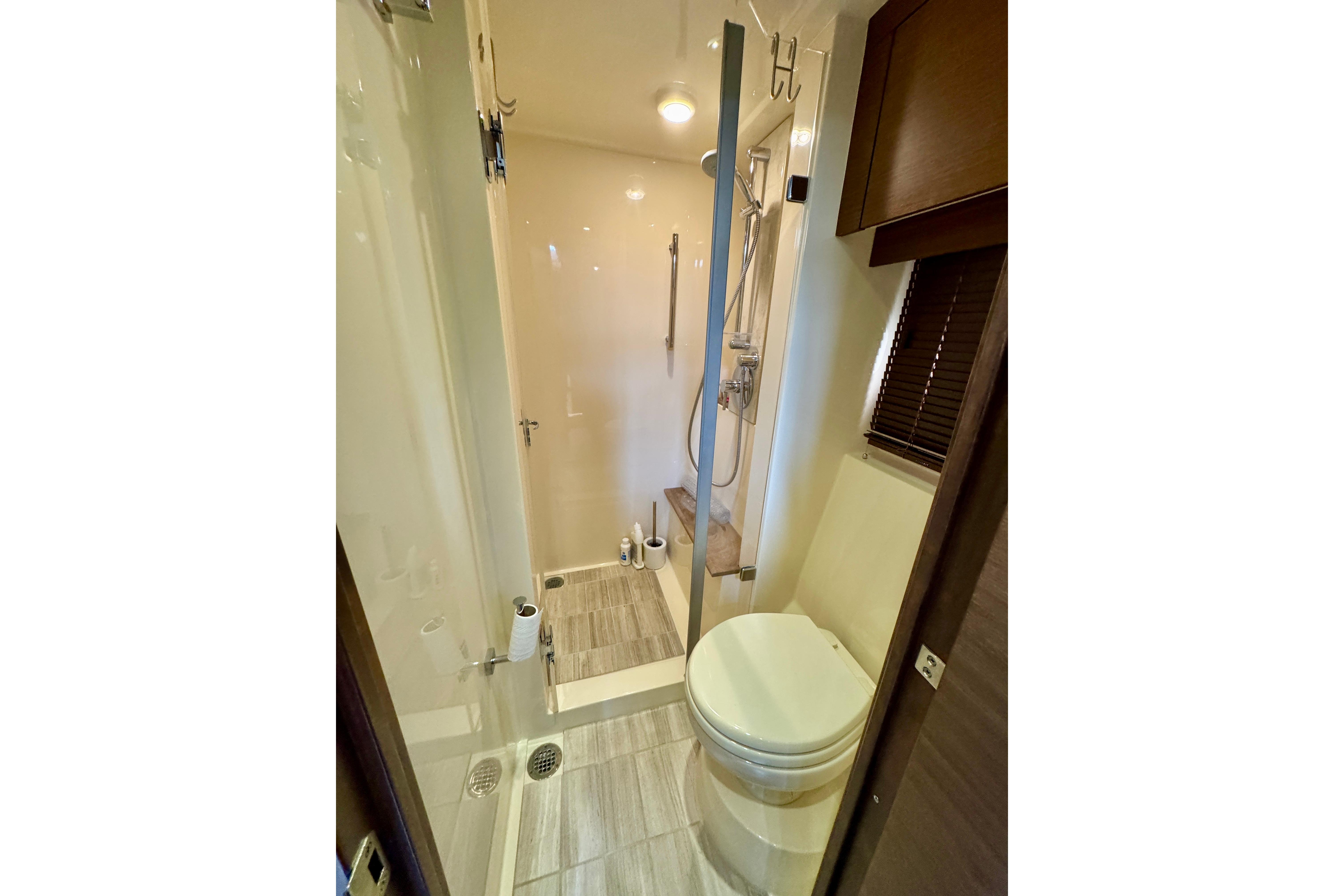 Luxurious bathroom in 2014 Sea Ray 510 Sundancer yacht with shower and toilet.