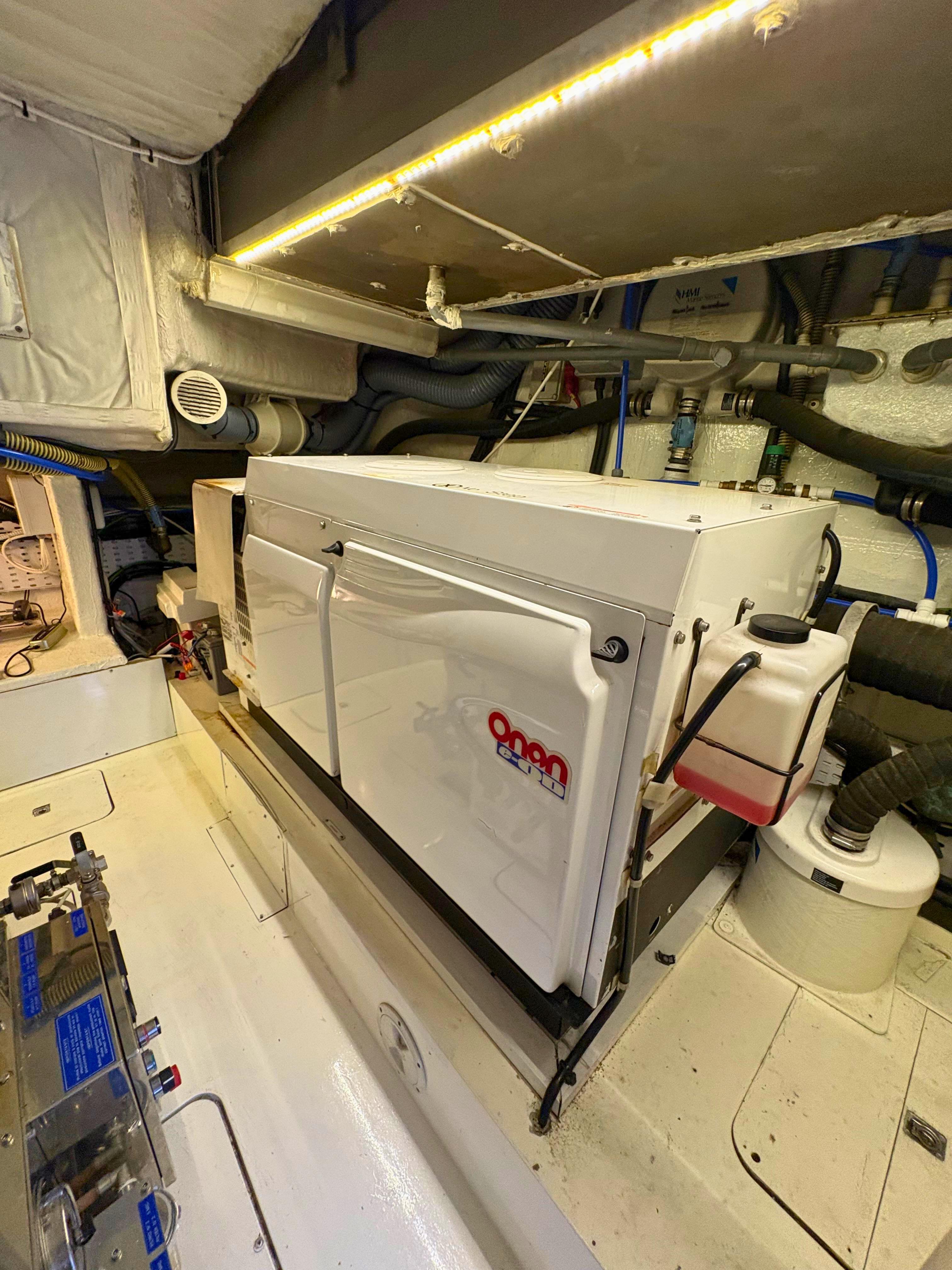 Engine room of 2007 Princess 21M yacht with Onan generator and mechanical components.