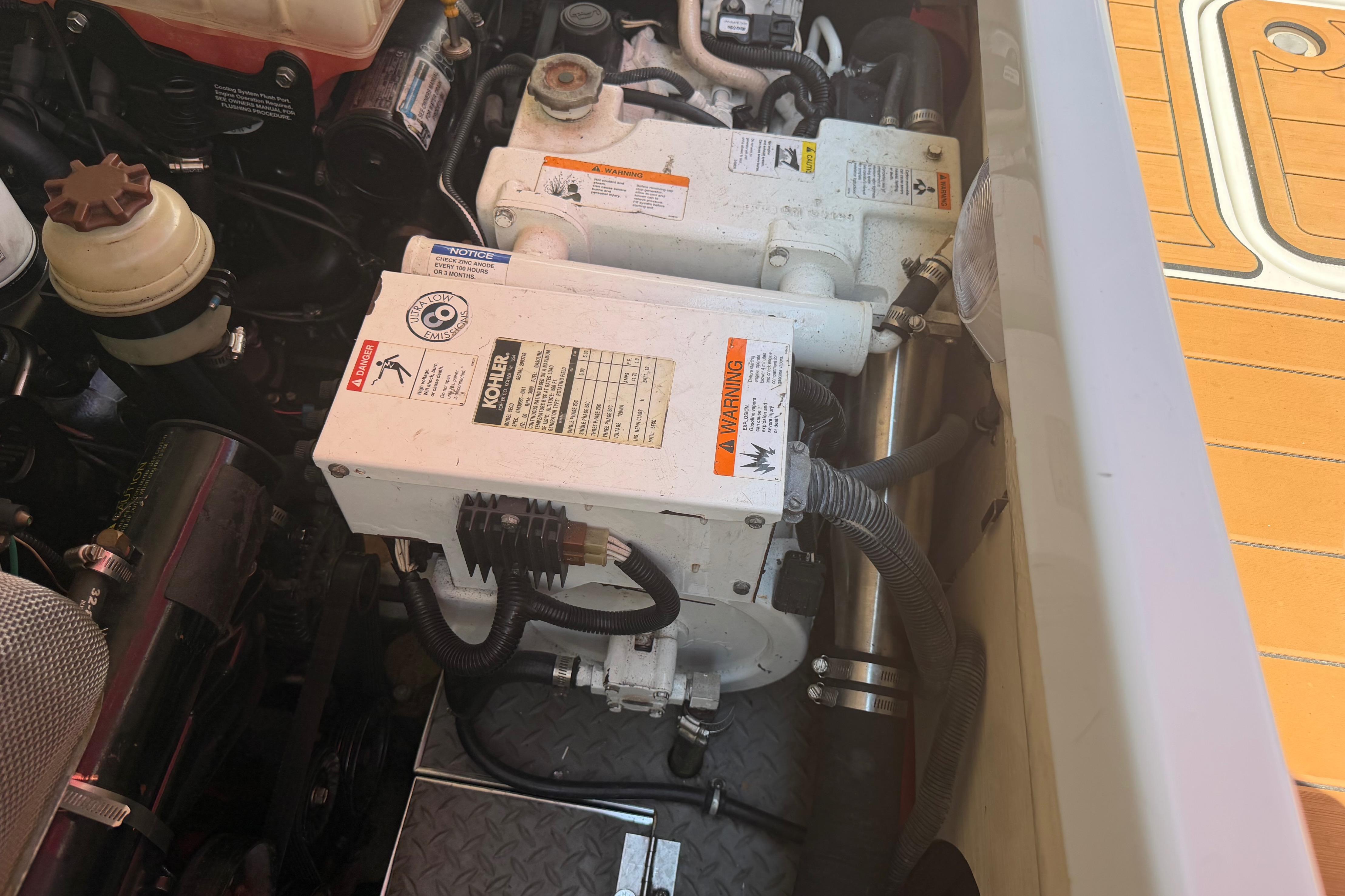Engine compartment of a 2006 Formula 330 Sun Sport boat, featuring Kohler generator components.