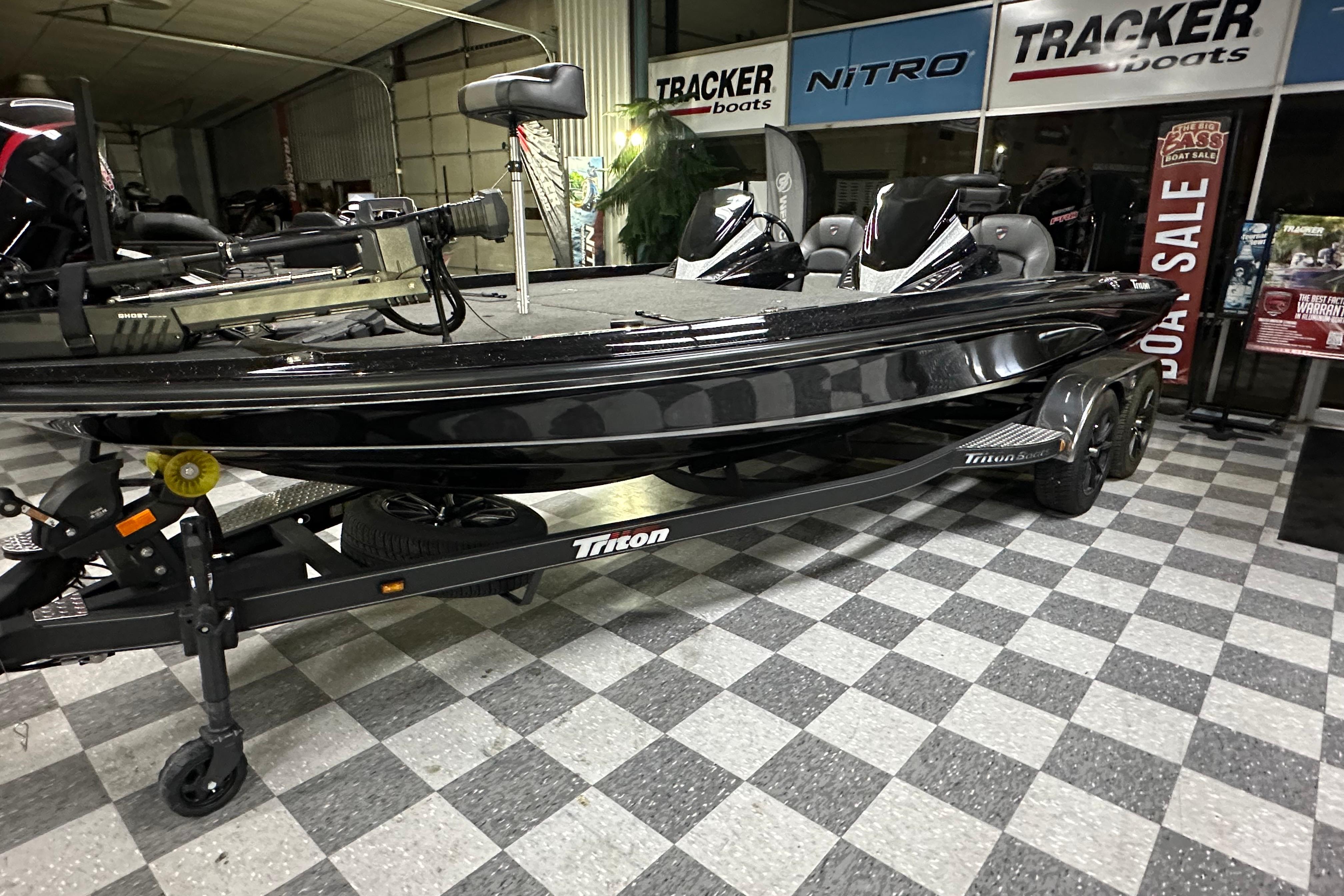 2025 Triton 21XP Patriot boat on display in showroom with checkered floor.