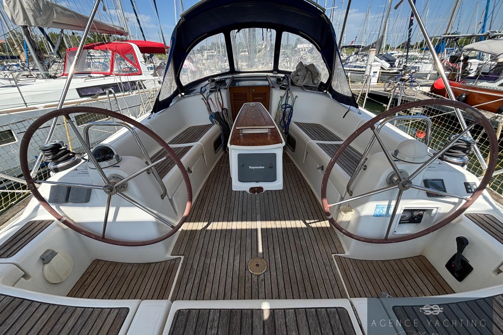 2008 Beneteau Oceanis 40 sailboat cockpit with dual steering wheels and wooden deck.