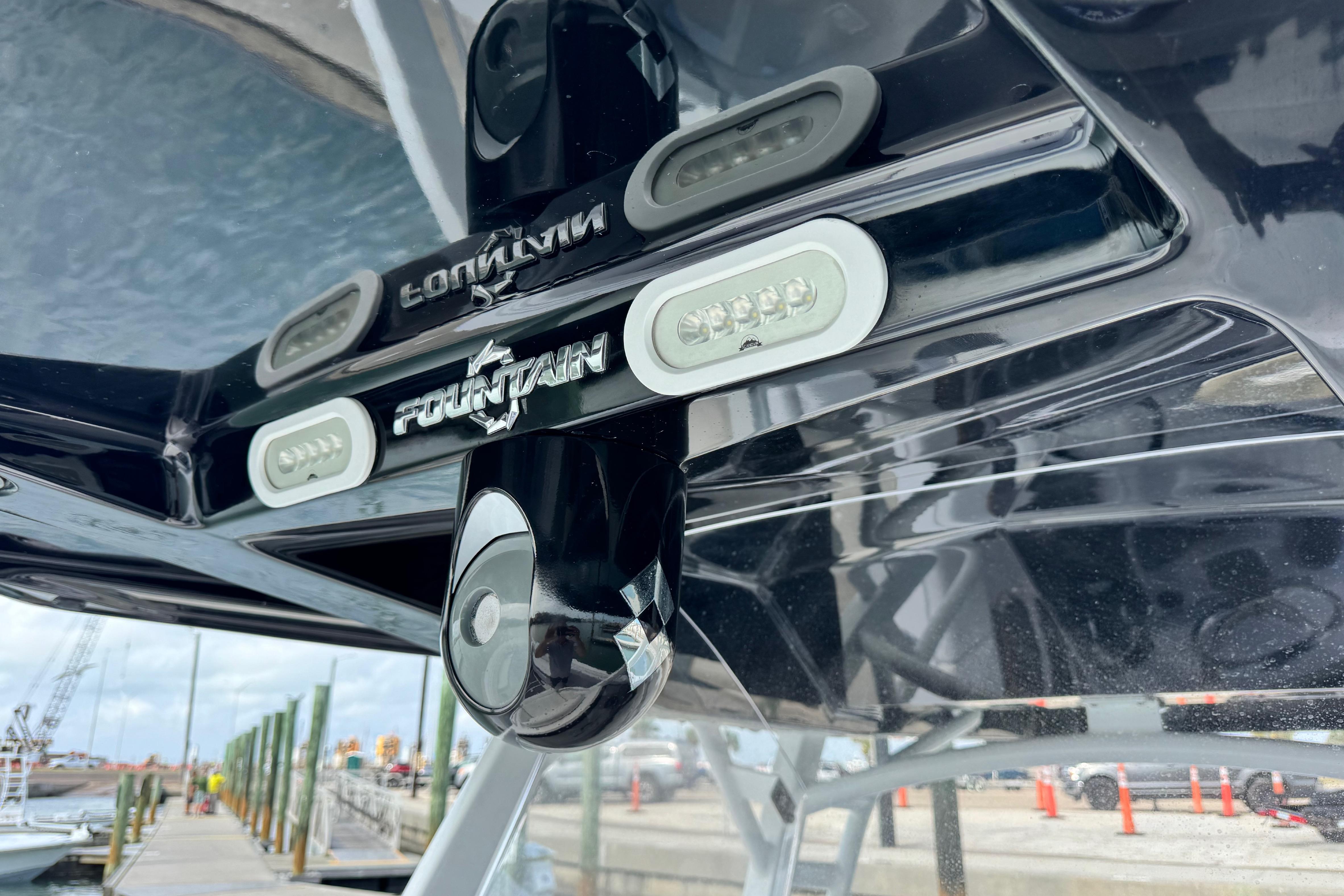 2018 Fountain 34 Center Console boat detail with logo and dock background.