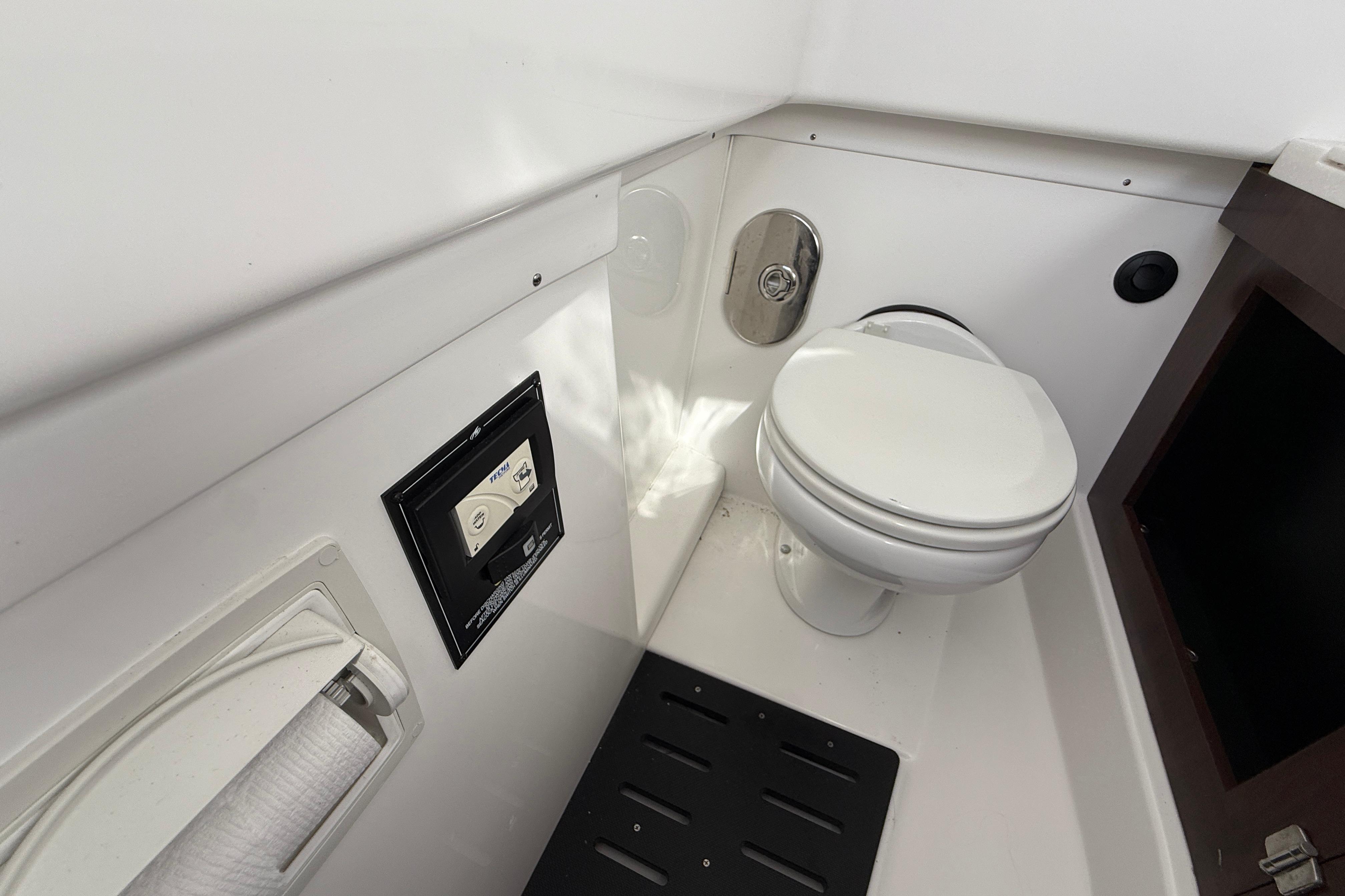 2022 Monterey 385SS Super Sport boat bathroom interior with toilet and control panel.