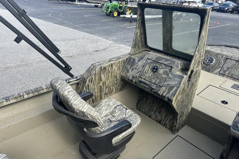 2025 SeaArk Predator 300 AK boat interior with camouflage seating and console.