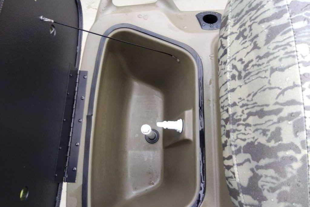 Livewell compartment in 2026 Tracker Grizzly 1860 CC boat, featuring camo seating.