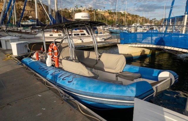 Nautica Rigid Inflatable Catamaran 2005 docked at marina.
