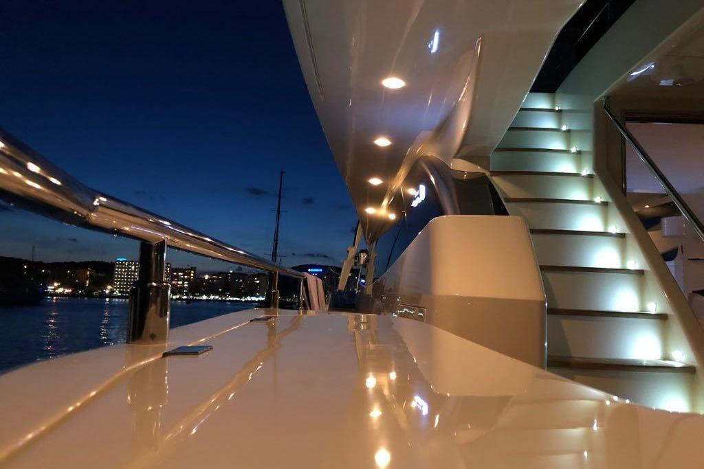 Luxurious 2008 Astondoa 76 GLX yacht deck at night with illuminated stairs.