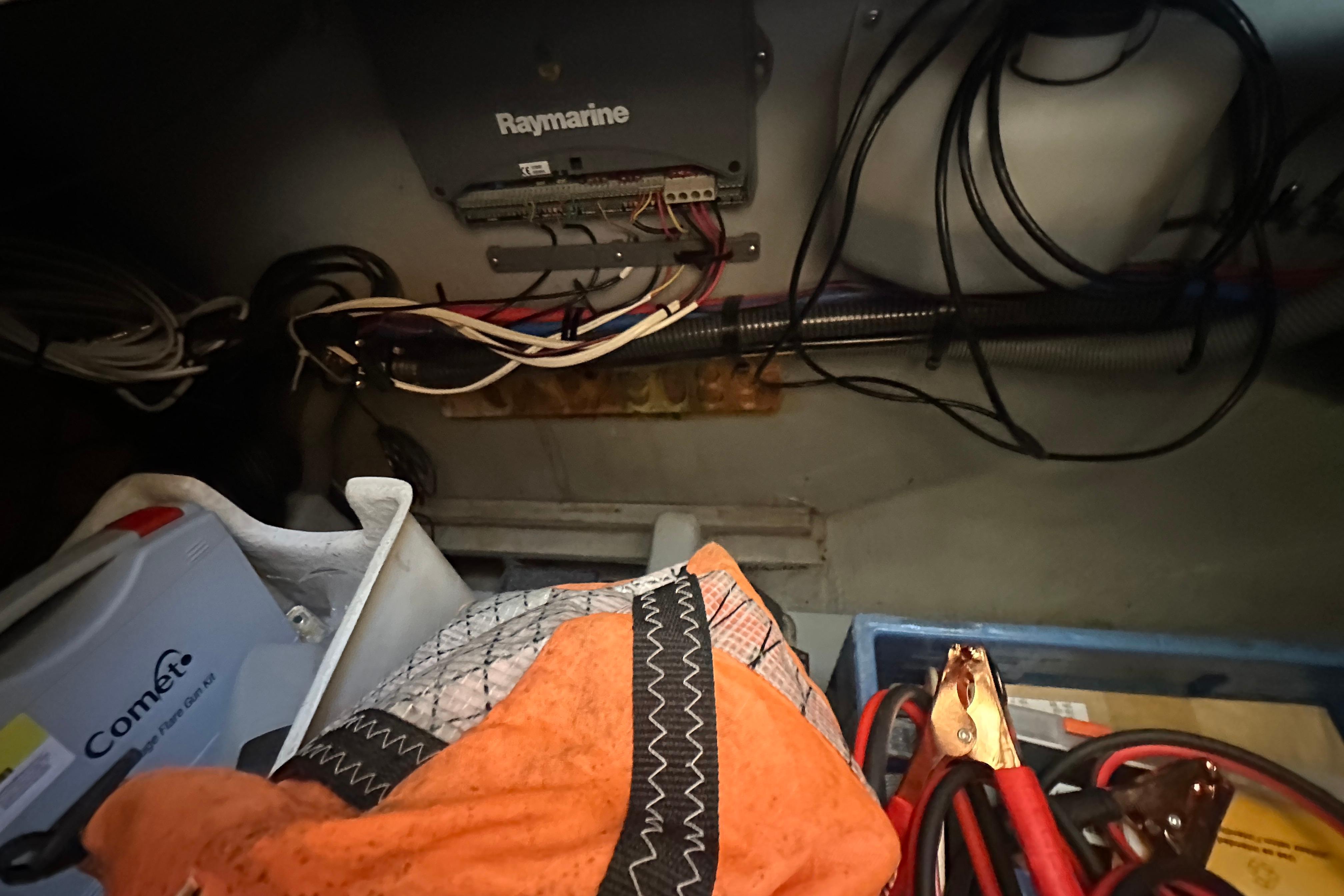 2002 Mainship 390 Trawler interior with Raymarine equipment and various boating supplies.