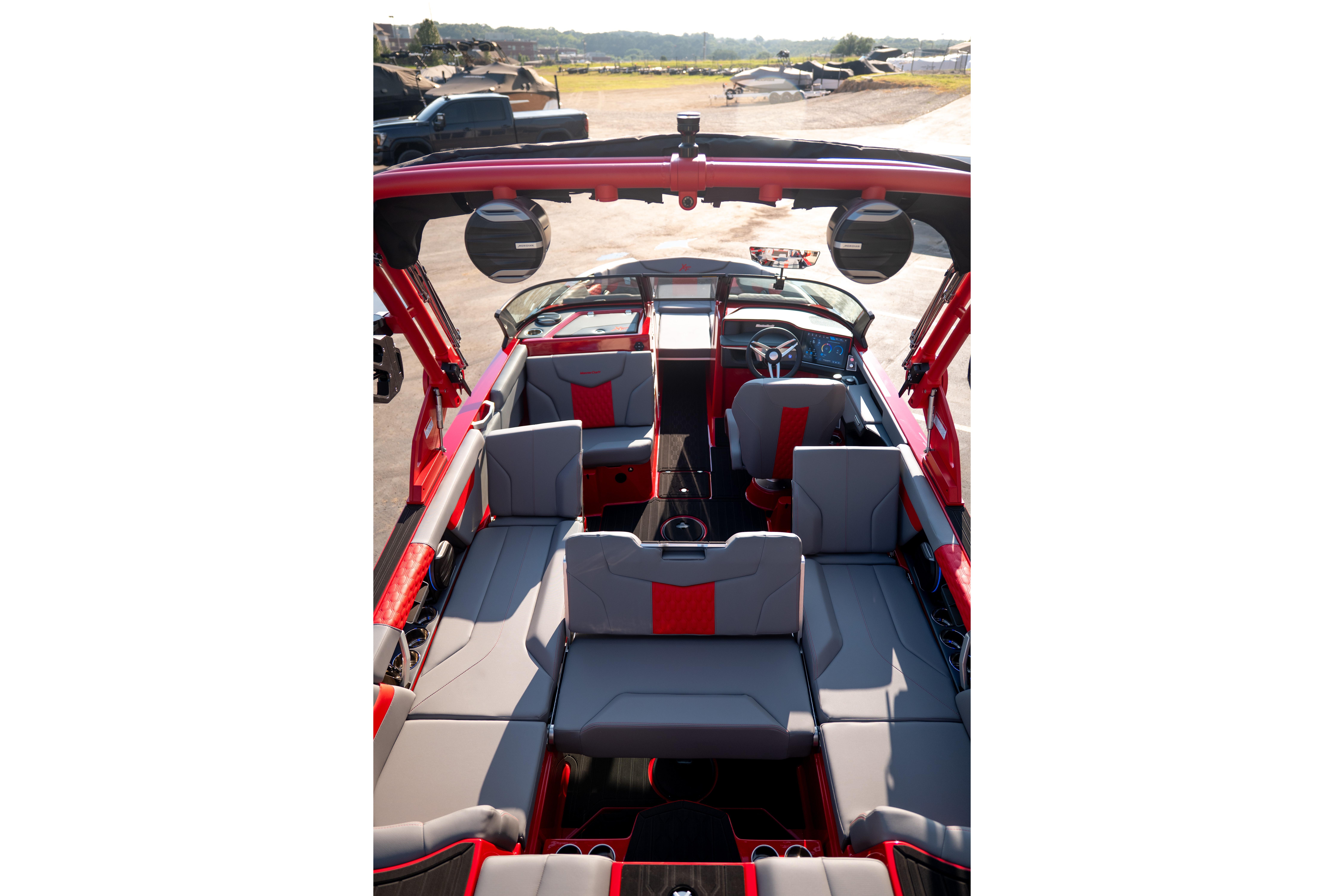 Interior of a 2027 MasterCraft XT24 boat with red and gray seating.