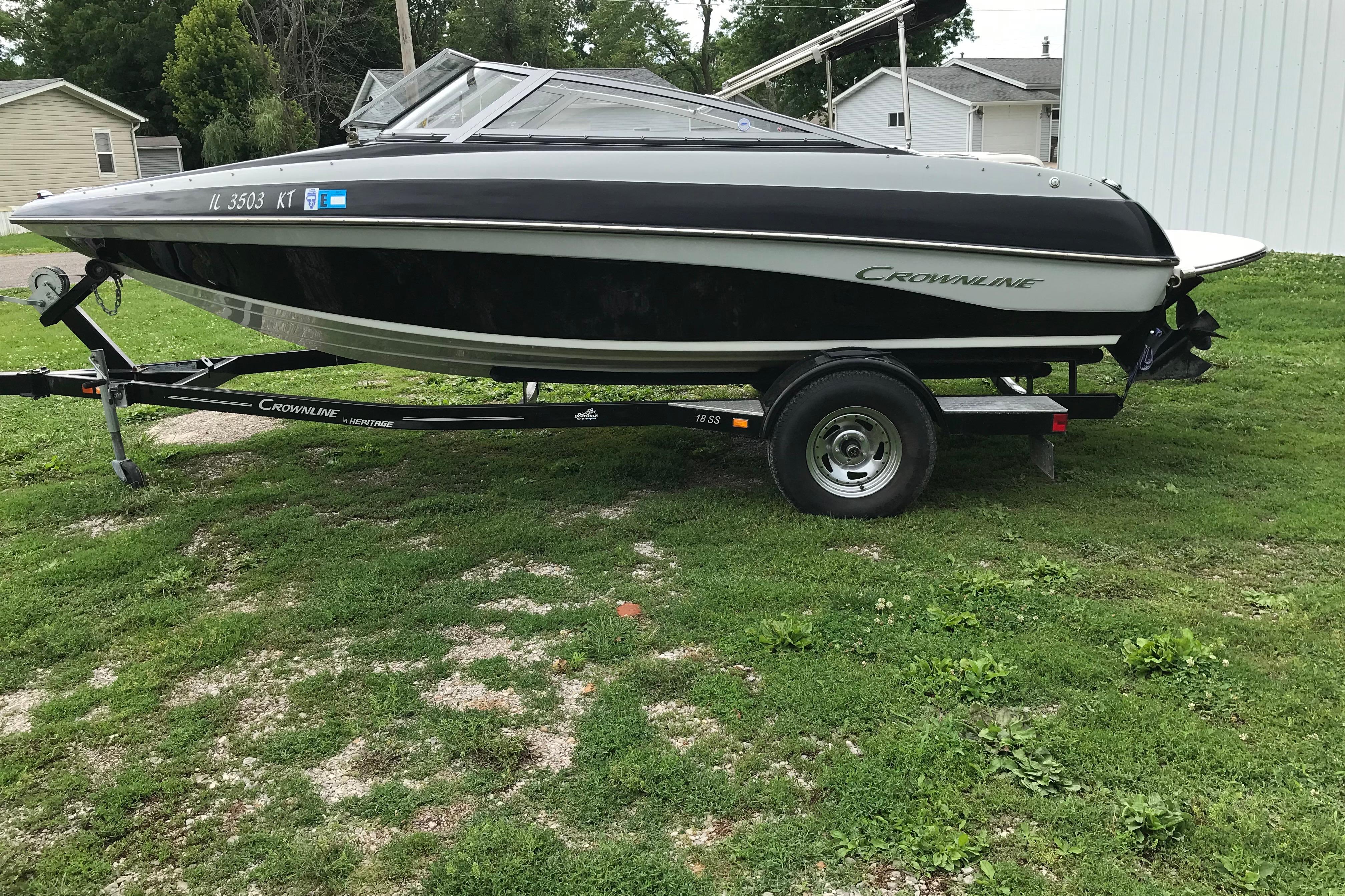 2015 Crownline 18 SS boat on trailer, parked on grass.