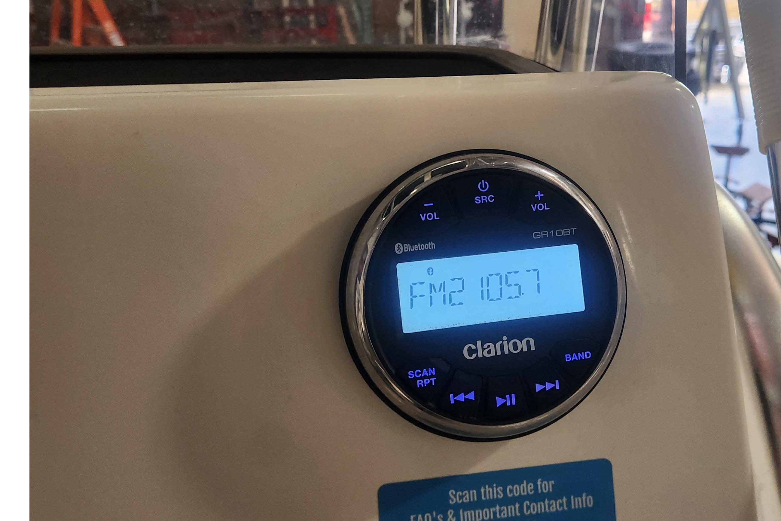 Clarion radio display on 2023 Key West 219 FS boat, tuned to FM 105.7.