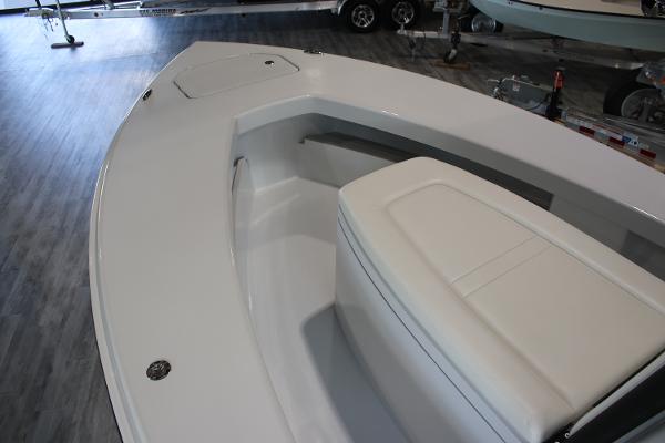 2025 East Cape 25 Open boat interior with seating and storage, displayed indoors.
