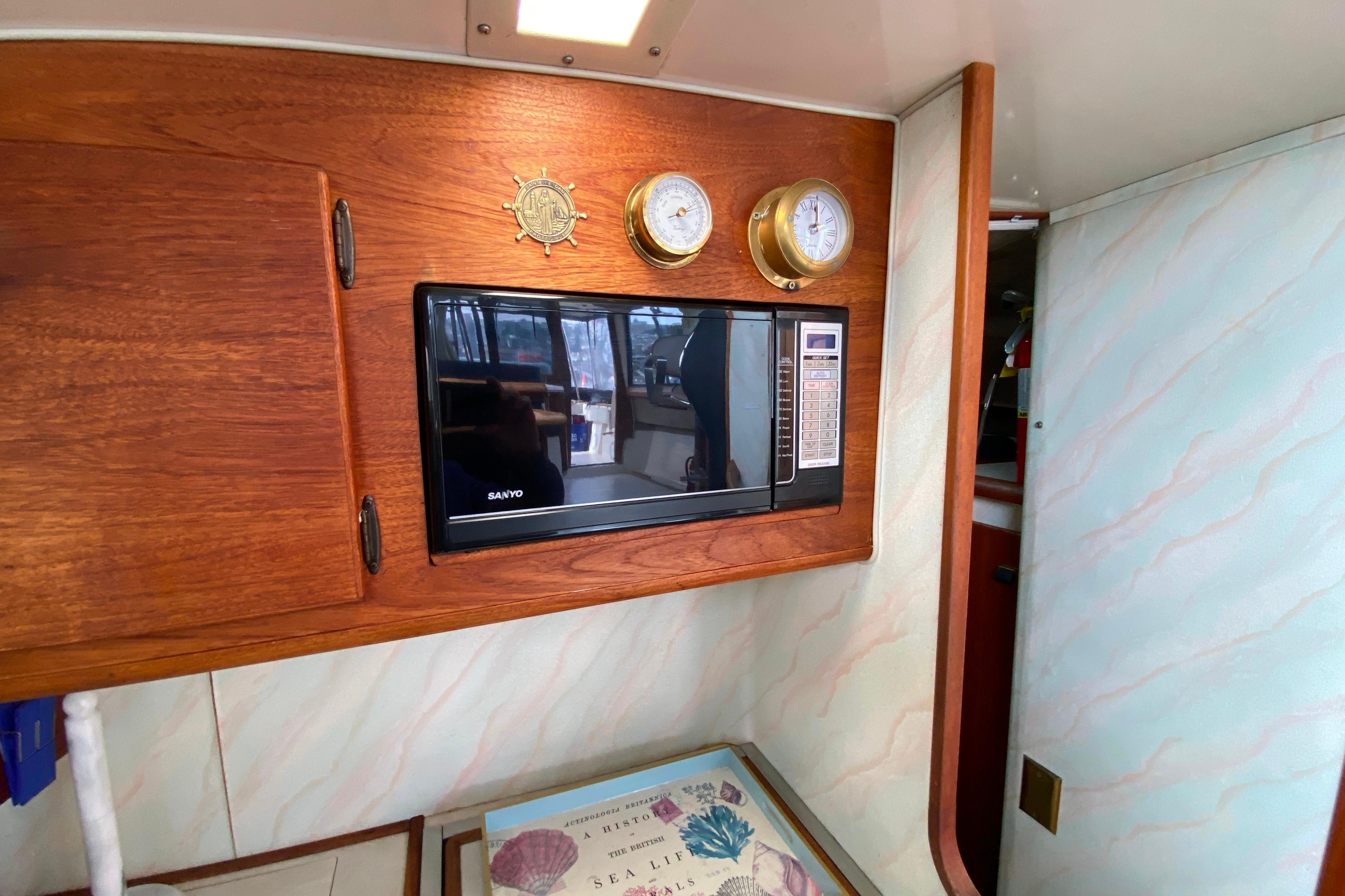 1989 Bayliner 3288 Motoryacht interior with microwave and nautical instruments.
