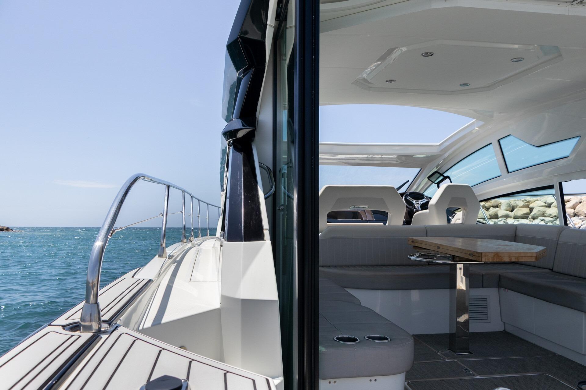 2019 Beneteau Gran Turismo 46 yacht interior and exterior view, featuring sleek design and ocean backdrop.