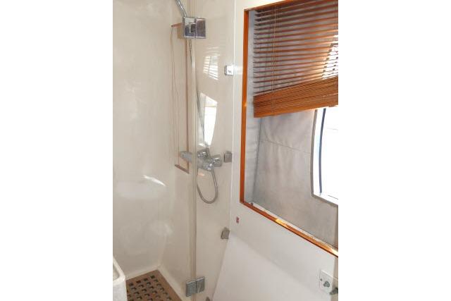 Shower area in 2014 Tayana Isara 50 yacht with wooden blinds and modern fixtures.