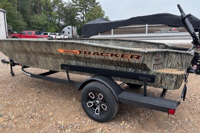 2026 Tracker Grizzly 1756 T Marsh boat on trailer, camo design, parked outdoors.