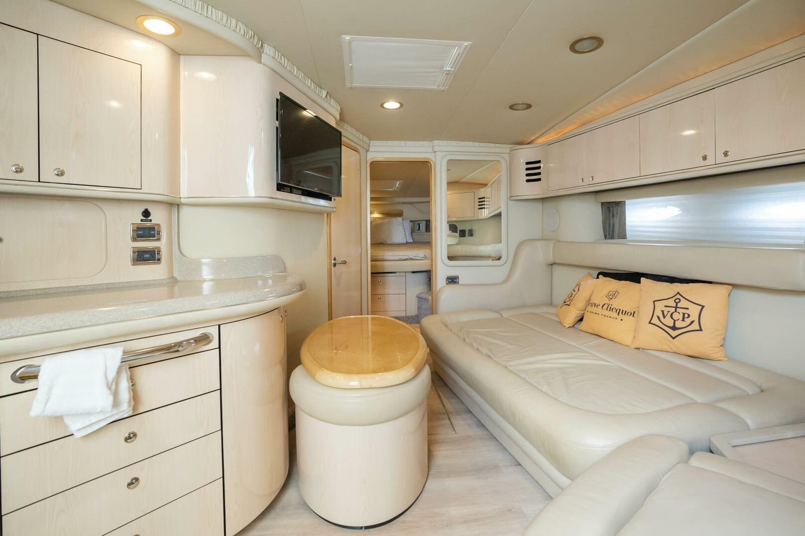 Luxurious interior of 2003 Sea Ray Sundancer 460 yacht with elegant seating and cabinetry.