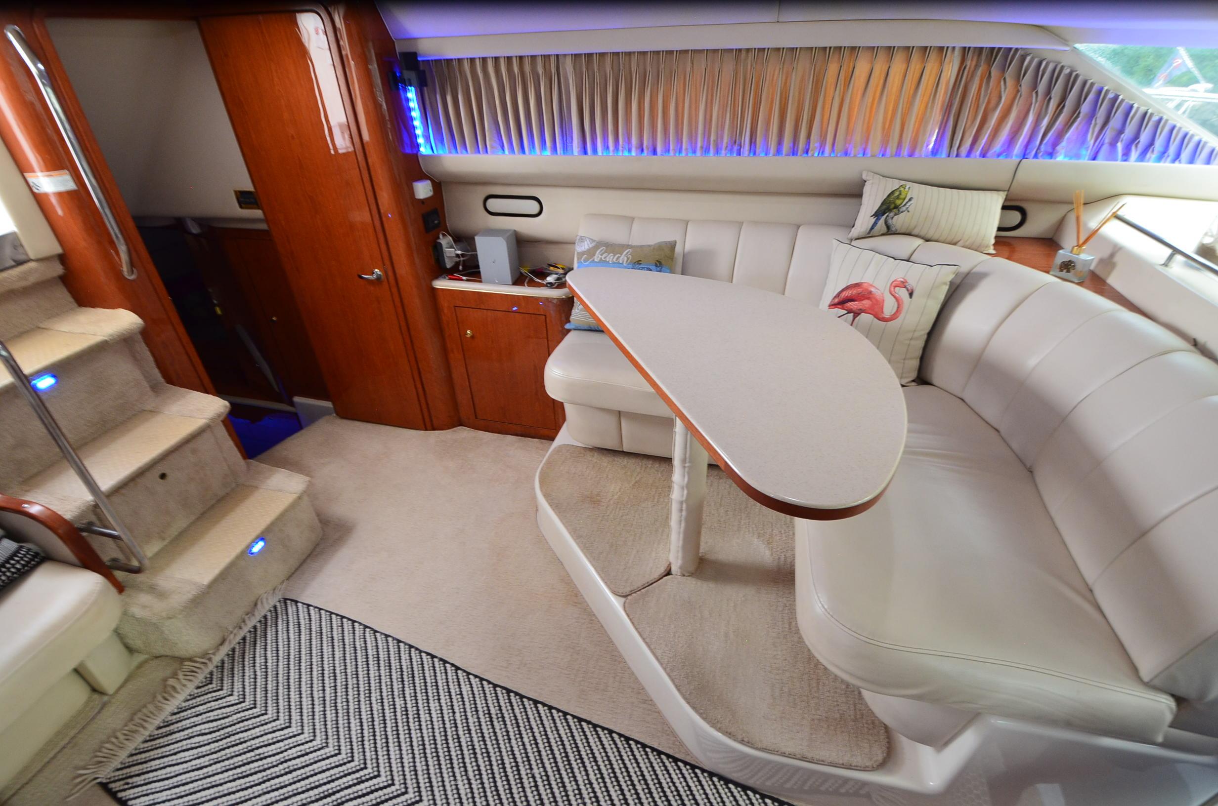 Luxurious interior of 2000 Sea Ray 420 Aft Cabin yacht with plush seating and elegant decor.