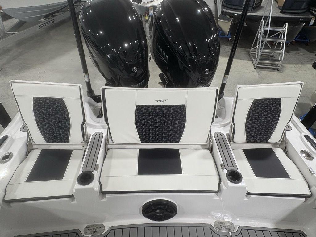 2026 Tidewater 2700 CB boat seats with dual outboard motors in showroom.