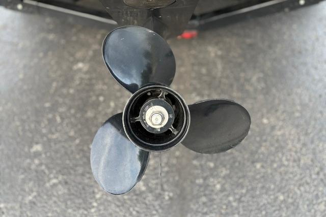 Propeller of 2017 Searay SPX210 boat on asphalt surface.