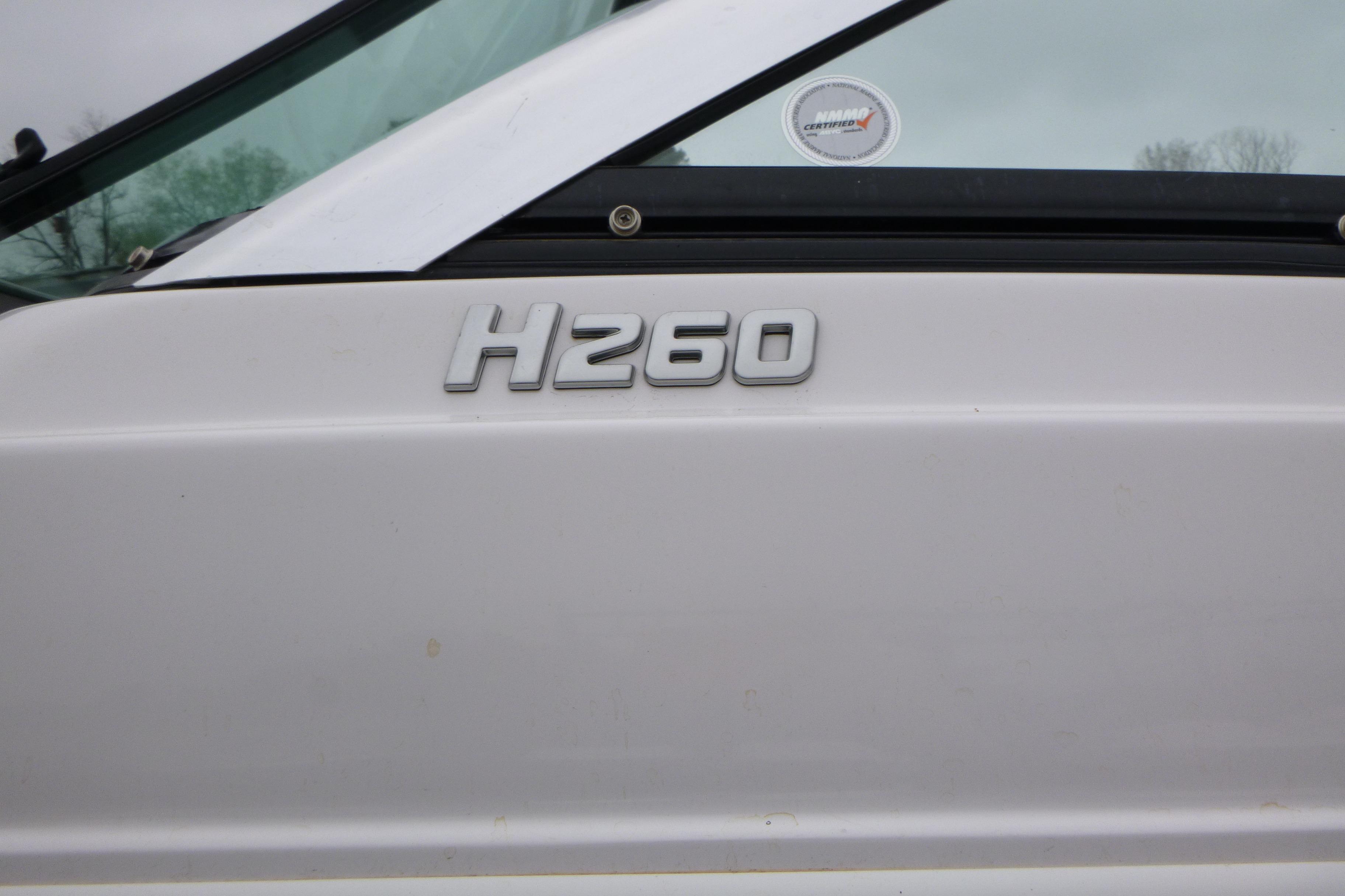 2017 Four Winns H260 boat model emblem on white surface.