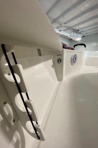 2024 Key West 250 Bay Reef boat interior with rod holders and speaker.
