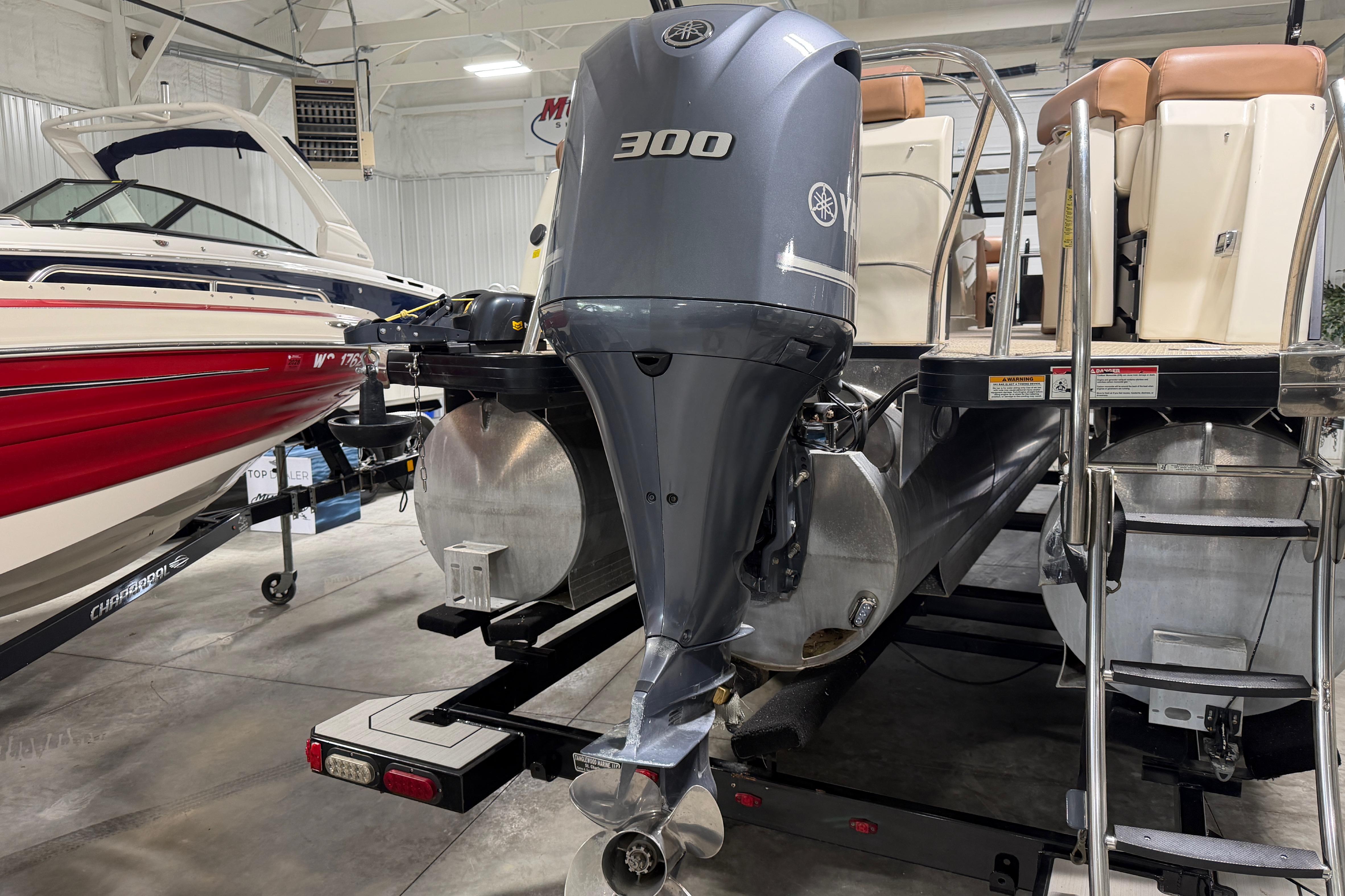 2018 Godfrey Sanpan 2500 ULC pontoon boat with Yamaha 300 outboard motor in showroom.