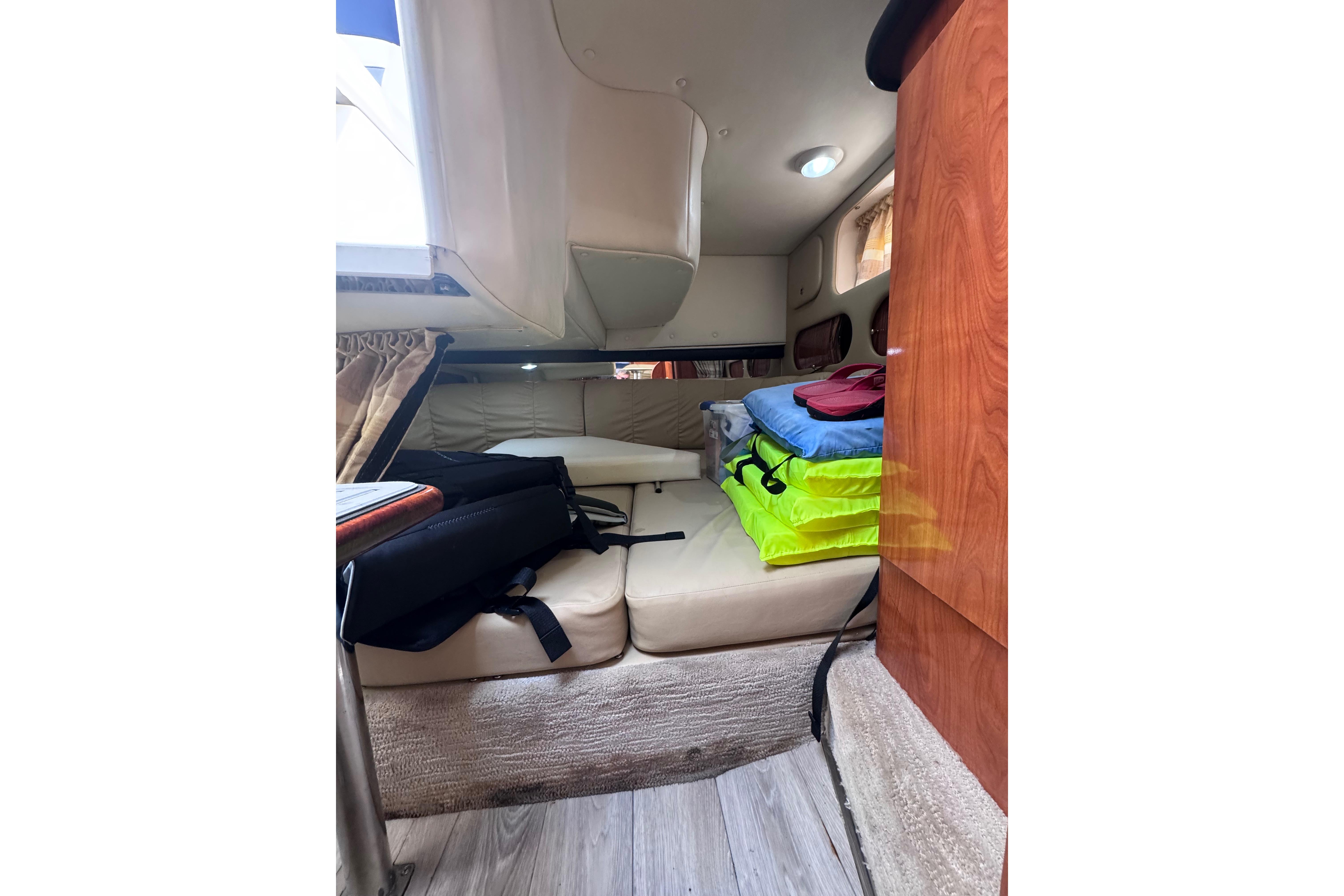 2003 Rinker Fiesta Vee 312 cabin interior with seating and storage.
