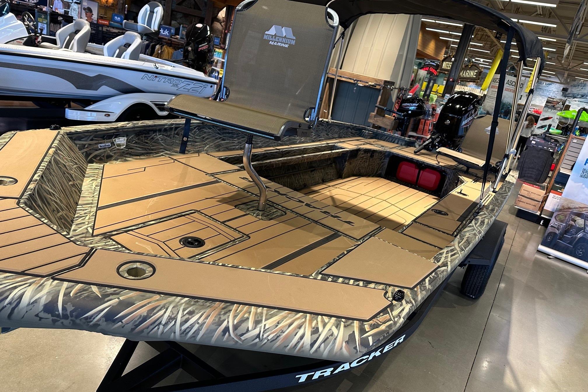 2026 Tracker Grizzly 1756 T Marsh boat with camouflage design on display indoors.