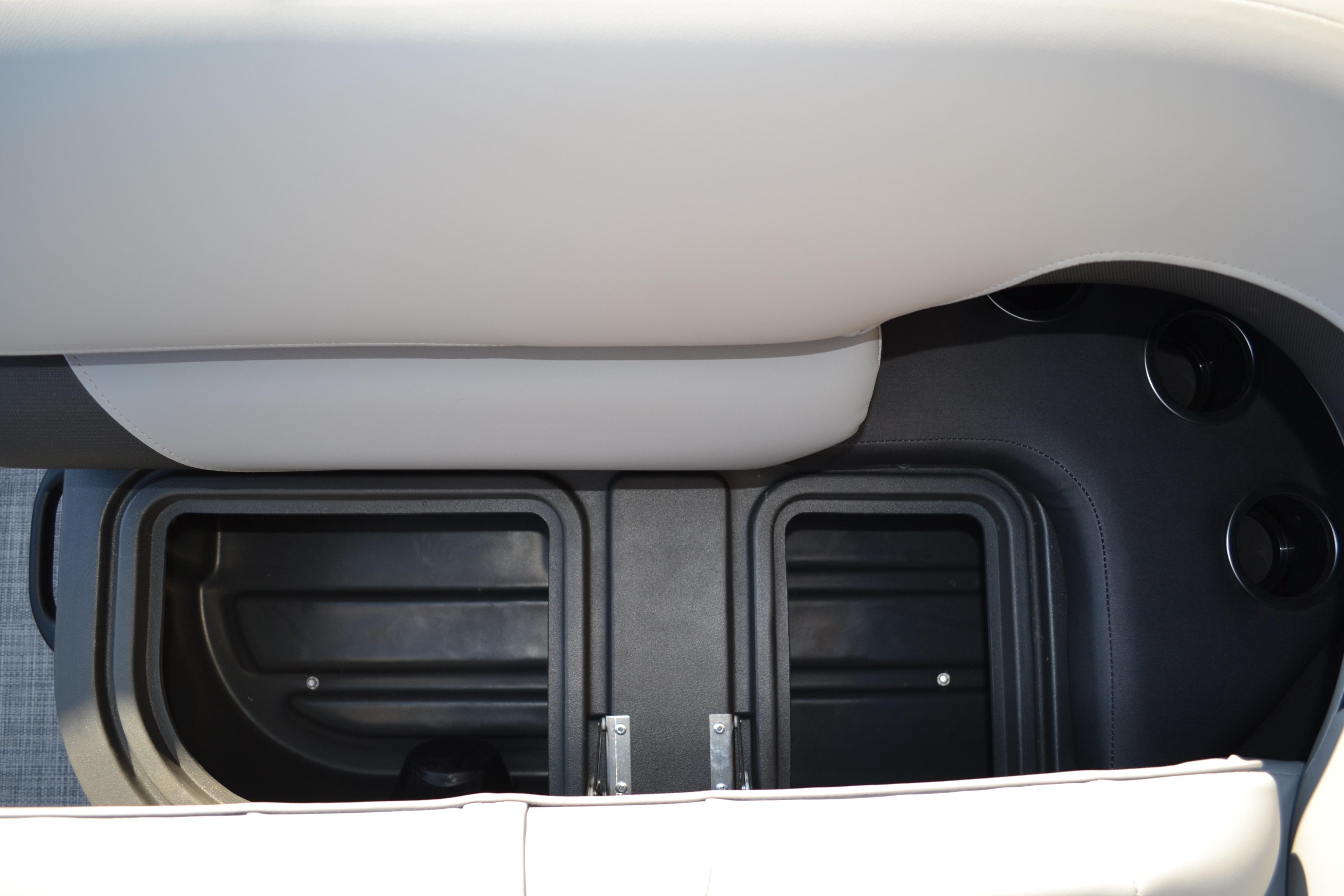 2026 Sun Tracker SportFish 22 XP3 storage compartment with cup holders and cushioned seating.