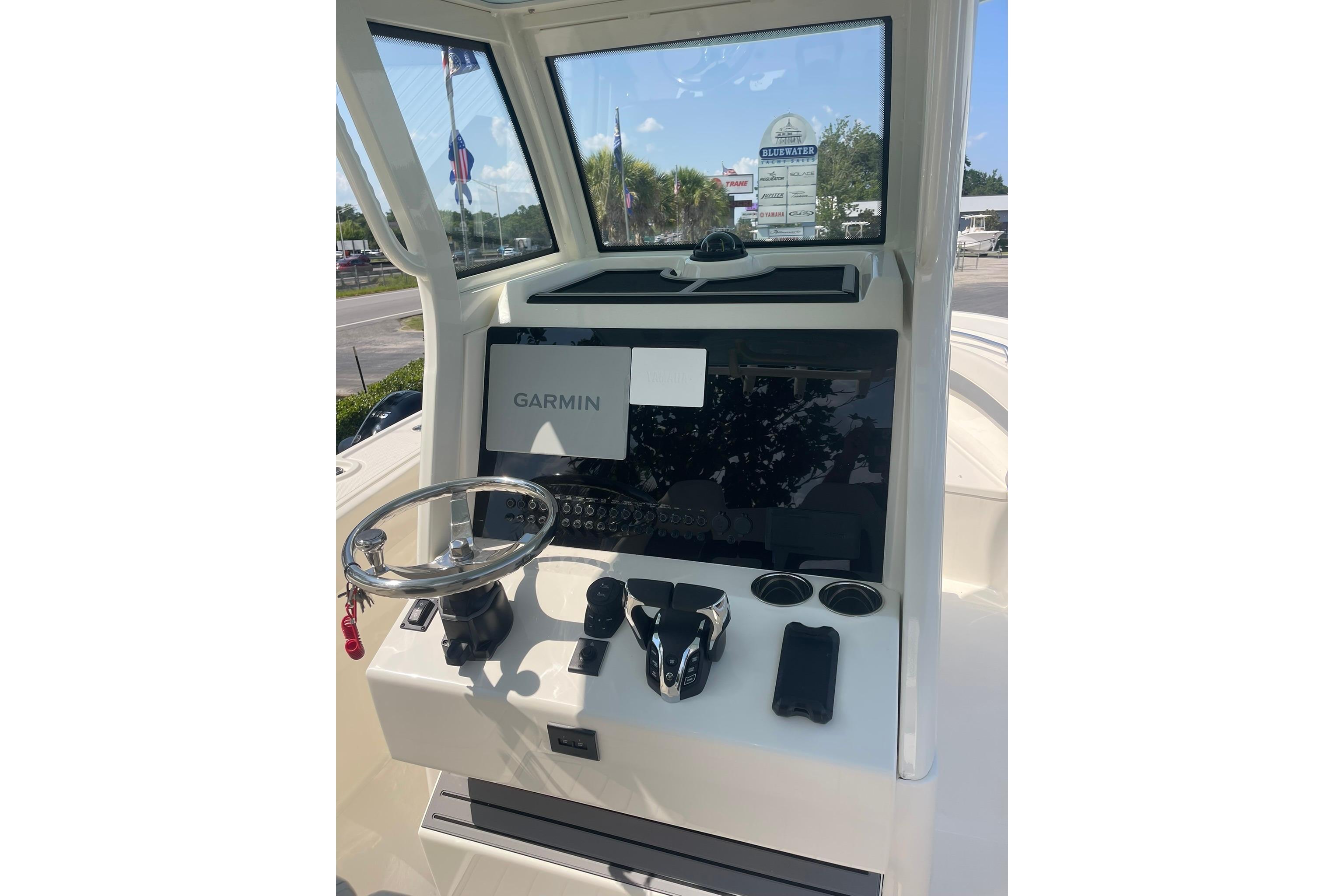 Helm of 2026 Pioneer 250 Pelagic boat with Garmin navigation system and steering wheel.