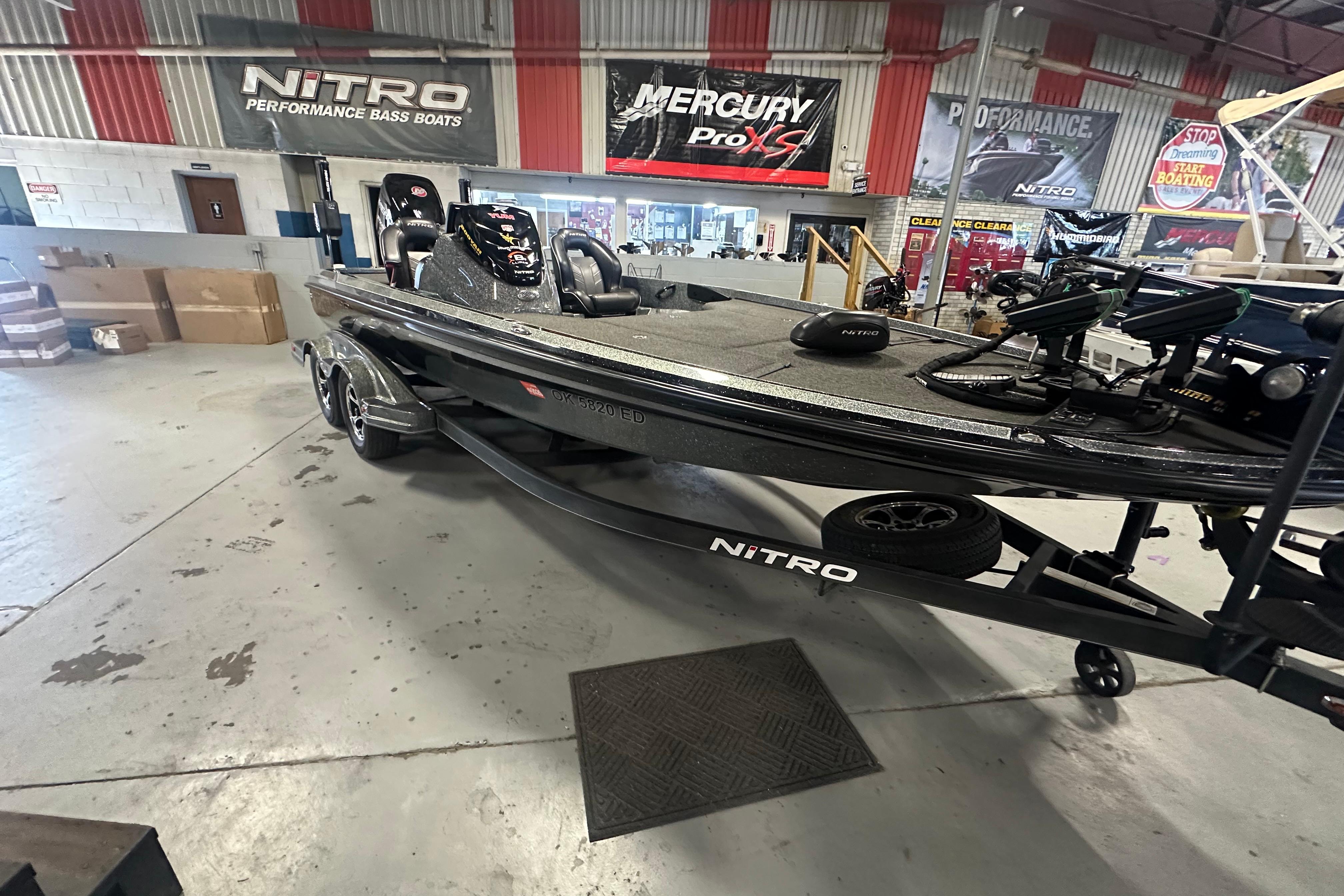 2018 Nitro Z20 Pro bass boat in showroom with performance banners.